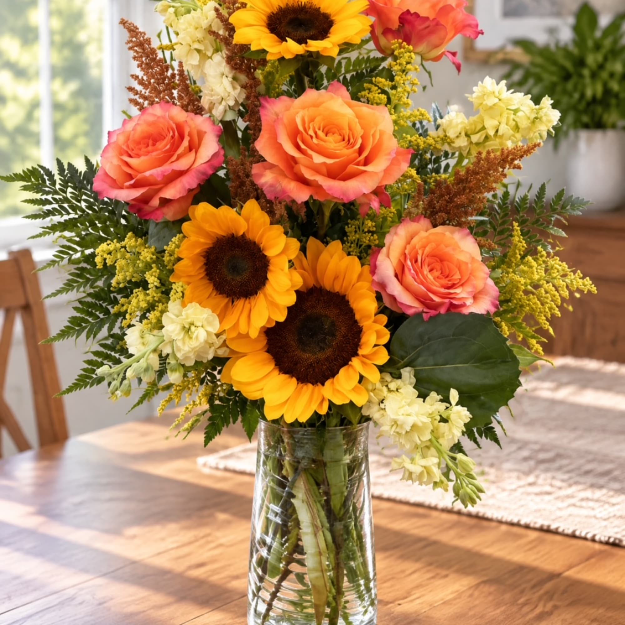 Bouquet of orange roses and sunflowers in a clear glass vase, photo 4 of 4