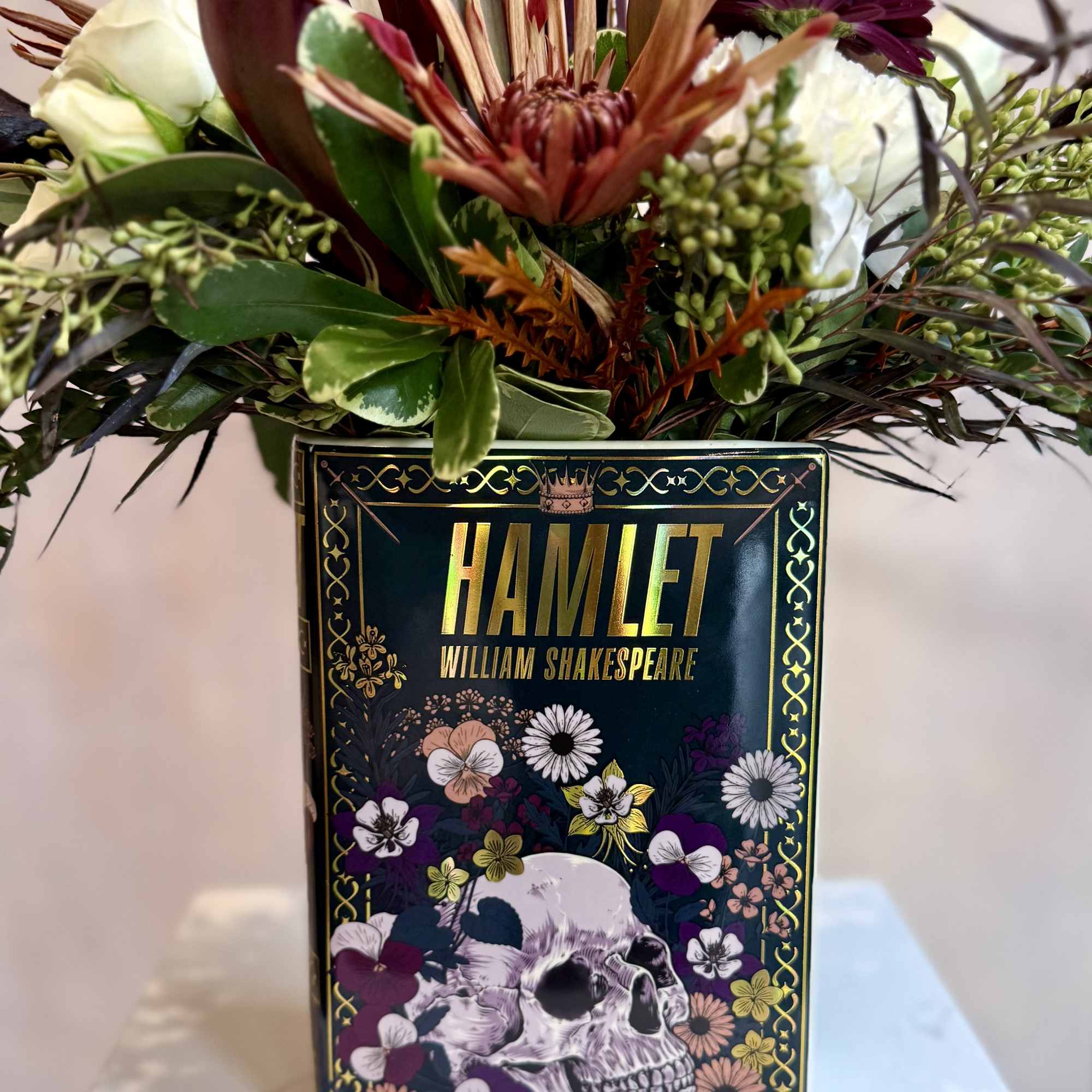 Mixed bouquet in a decorative Hamlet book box with dark blooms and white roses