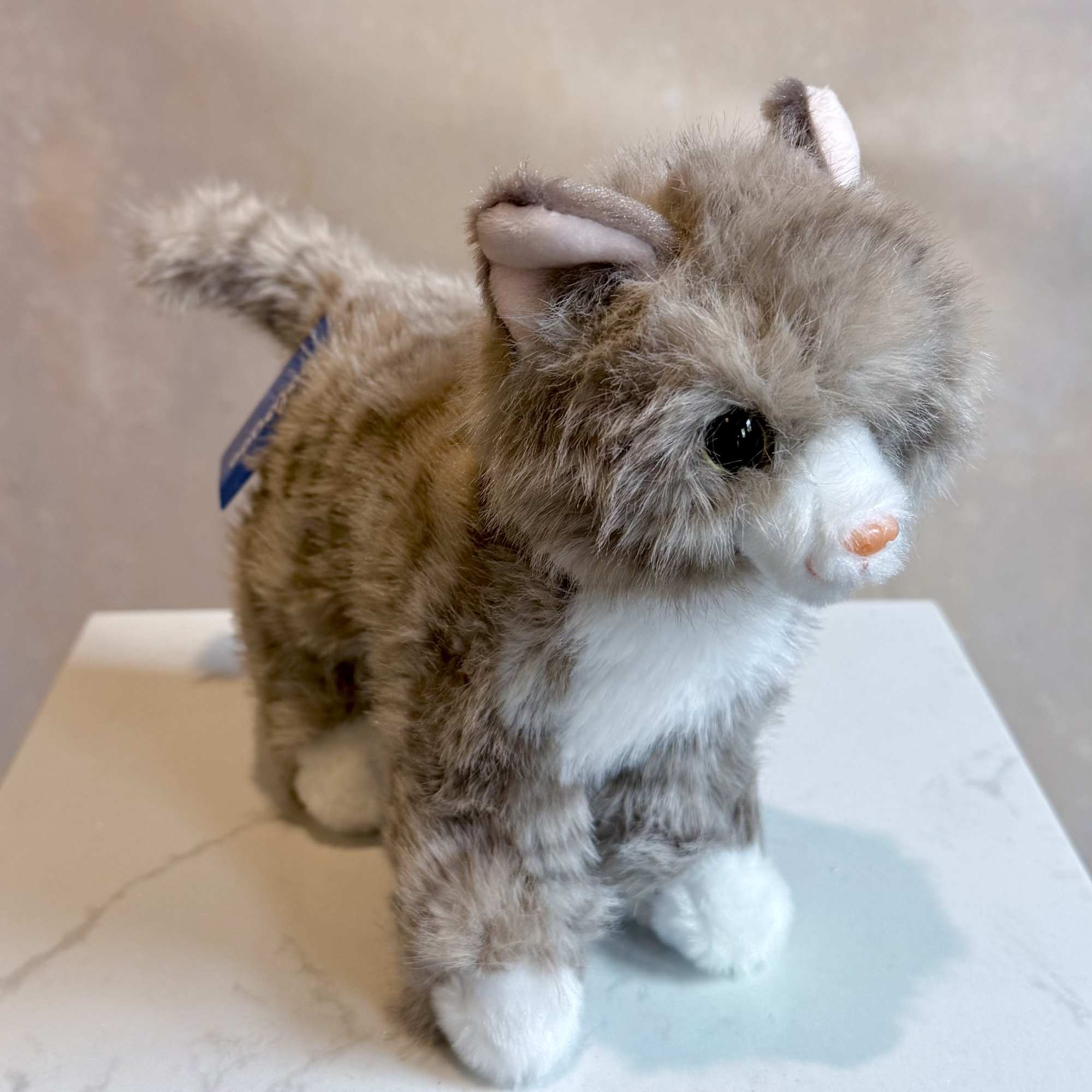 Plush cat figurine with fluffy brown and white fur