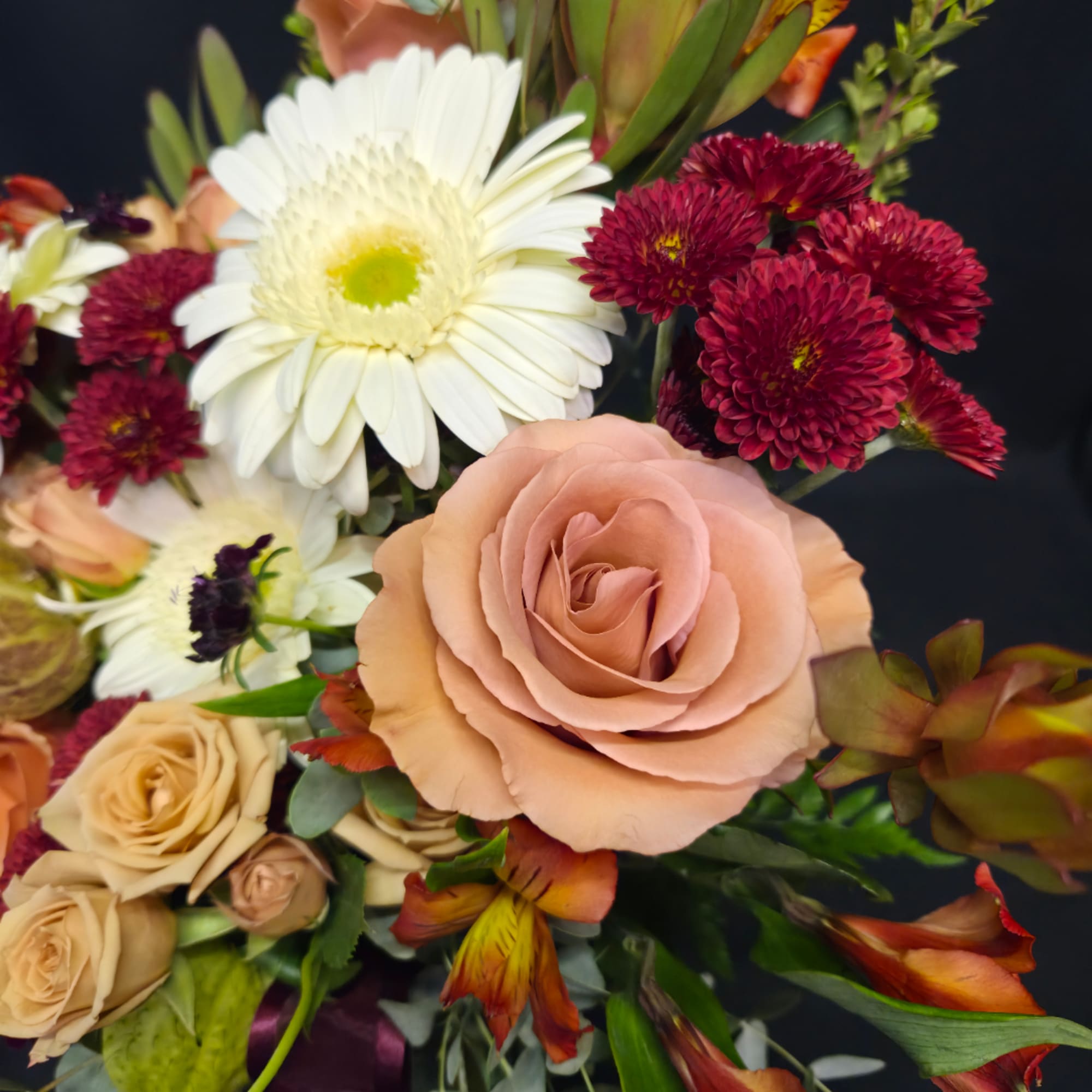 Bouquet of peach roses, white daisies, and burgundy mums