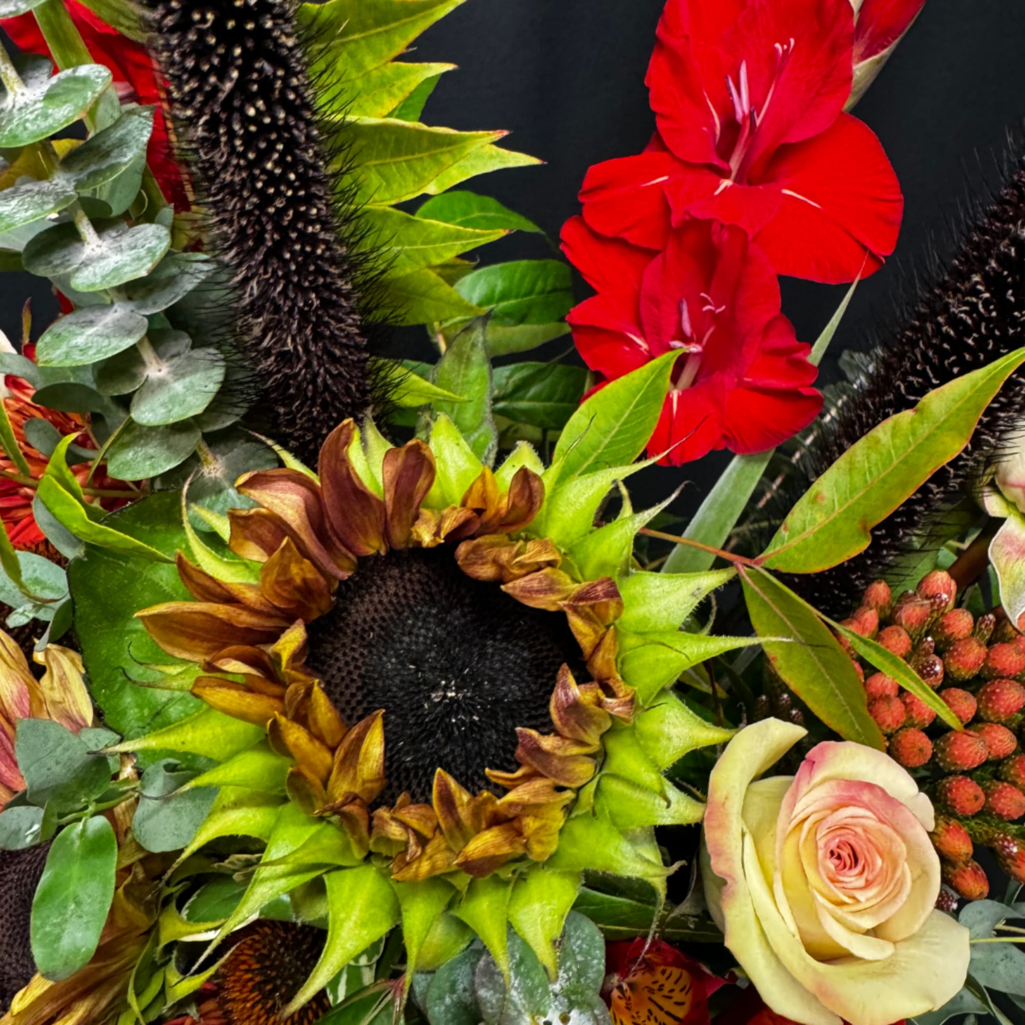 Bouquet with sunflowers, red gladiolus, and a pale rose