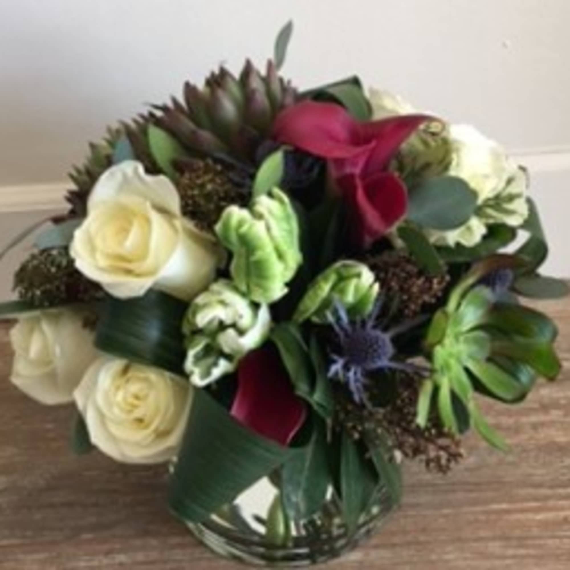 An organic mix of seasonal greens, succulents, roses and other seasonal flowers., photo 2 of 2