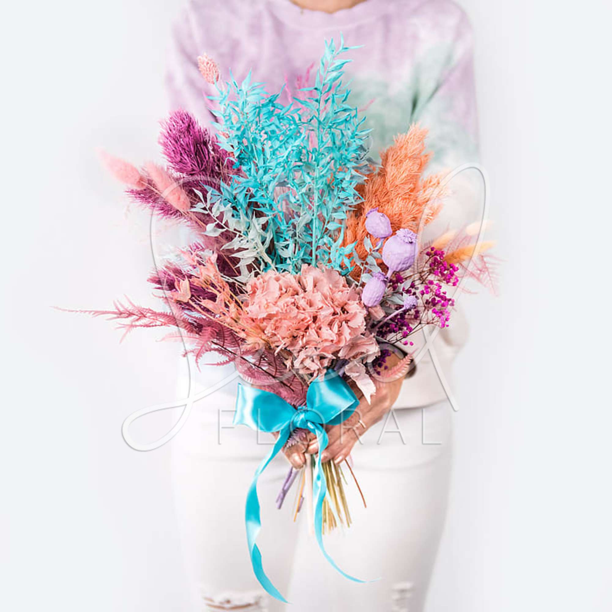 Colorful bouquet with pastel dried flowers tied with a blue ribbon
