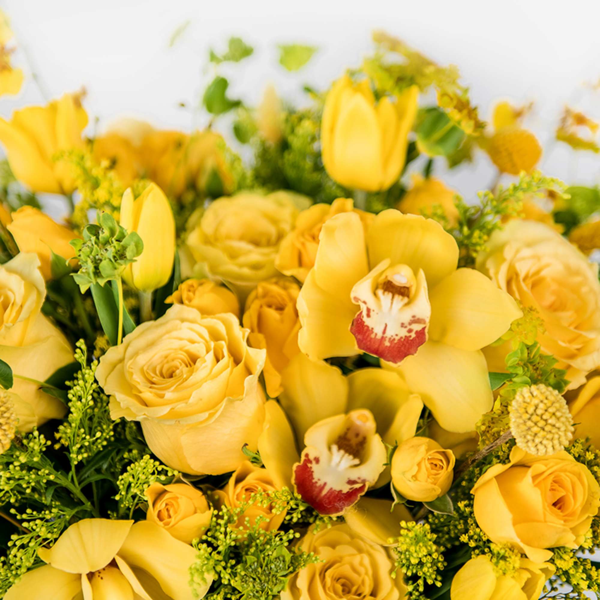Yellow roses and tulips with yellow orchids in a bouquet