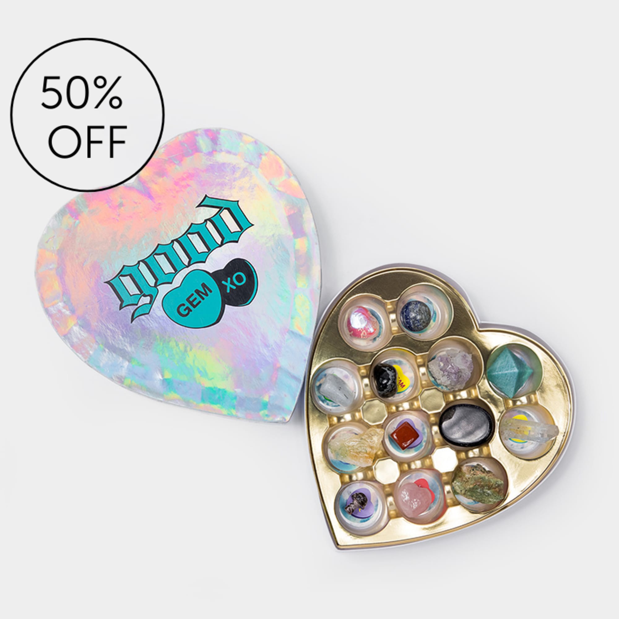 Heart-shaped gem assortment in a gold tray with an iridescent lid