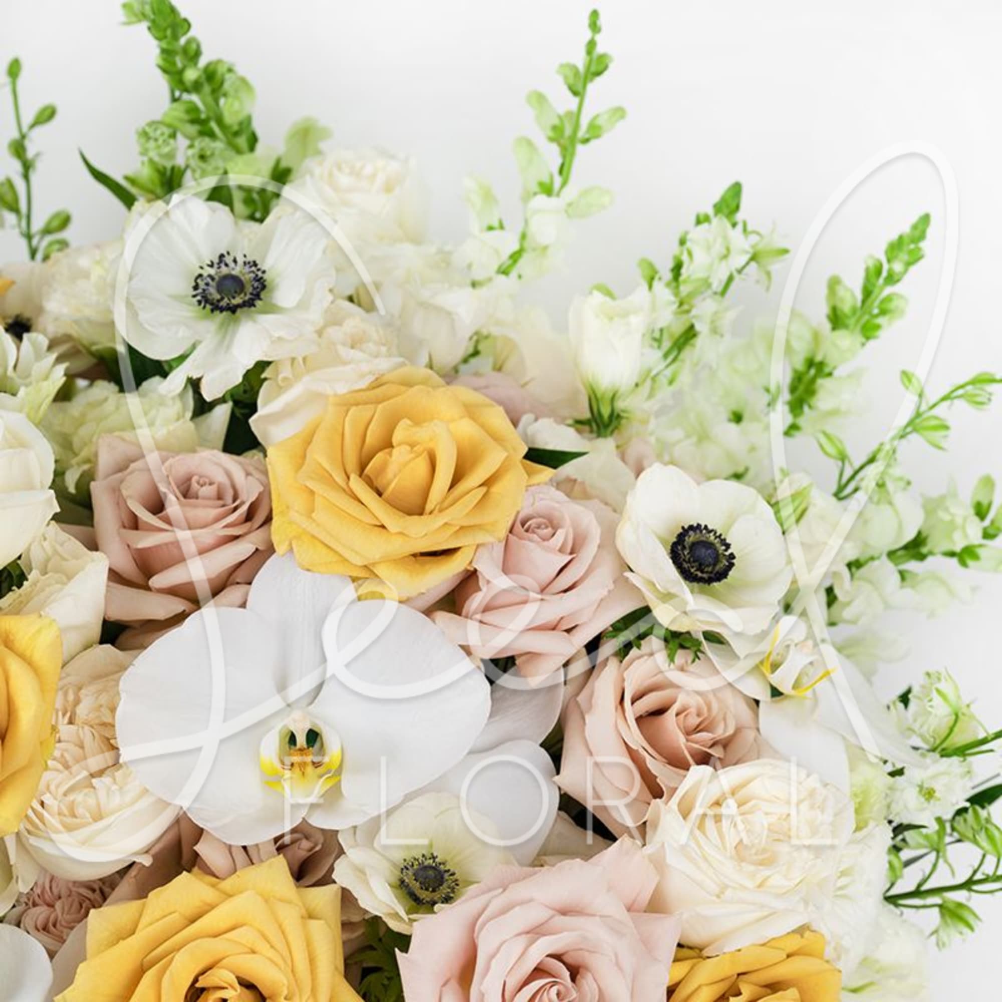 Bouquet of white anemones, pale roses, and yellow roses