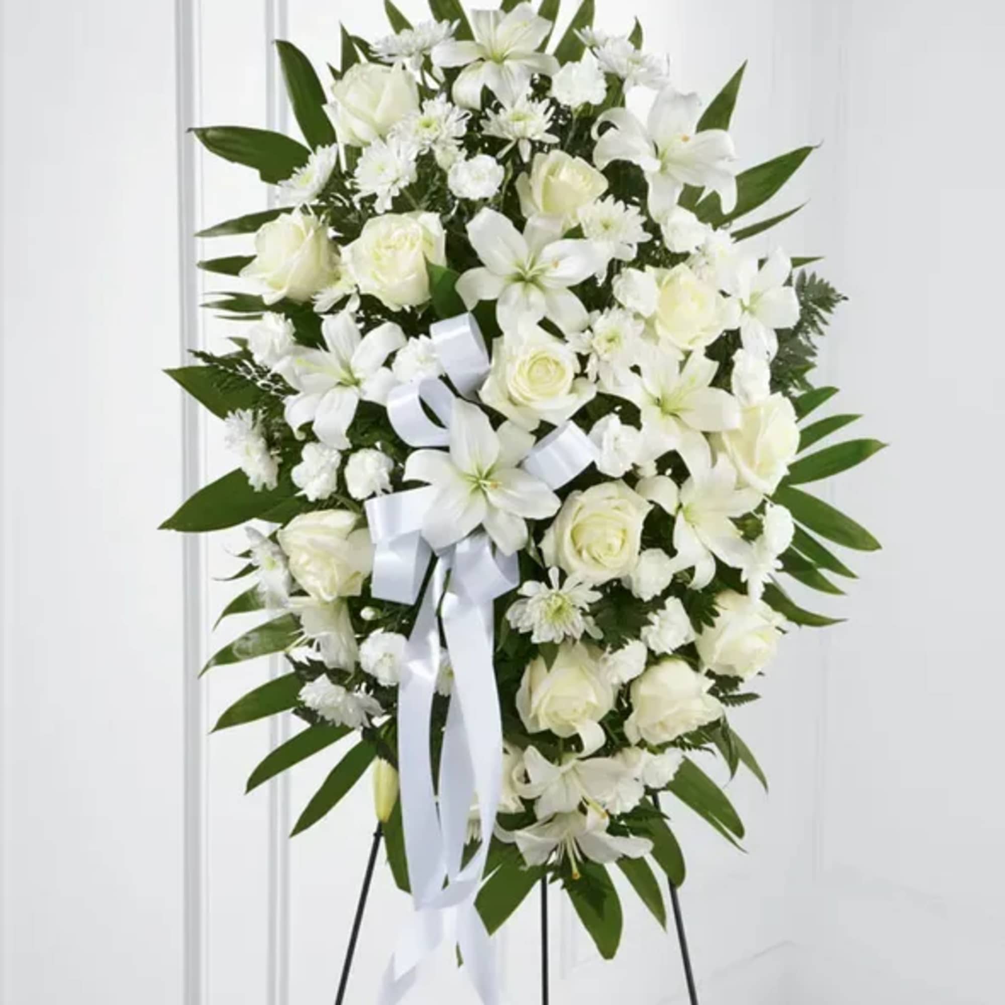The FTD Exquisite Tribute Standing Spray is an elegant display of sweet