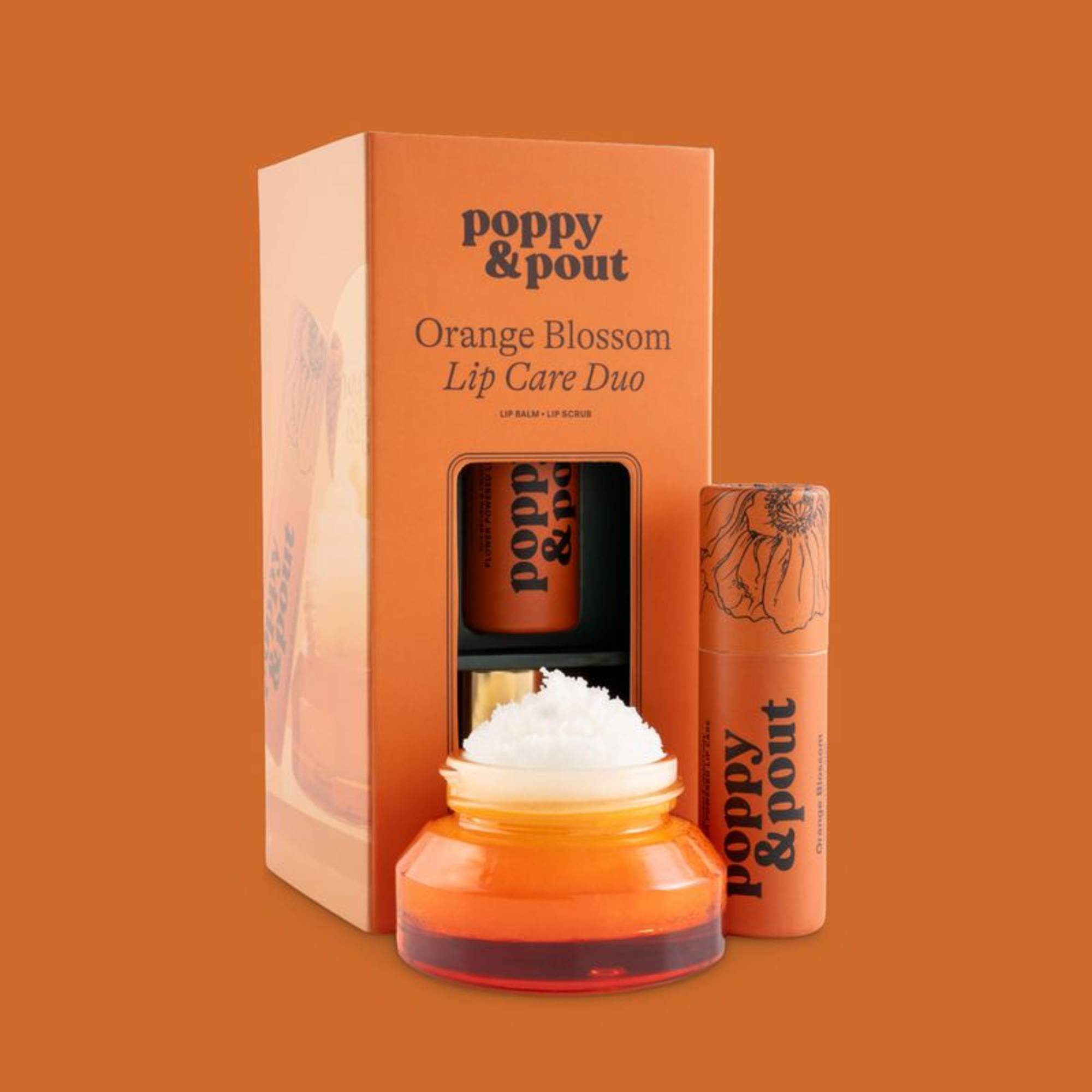 Orange lip care gift set with balm, scrub, and jar in branded packaging