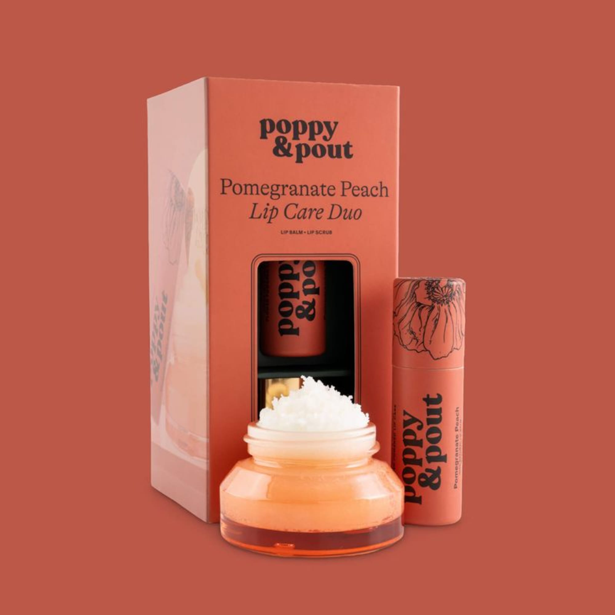 Pomegranate Peach lip care duo in coral packaging with a scrub jar and balm tube