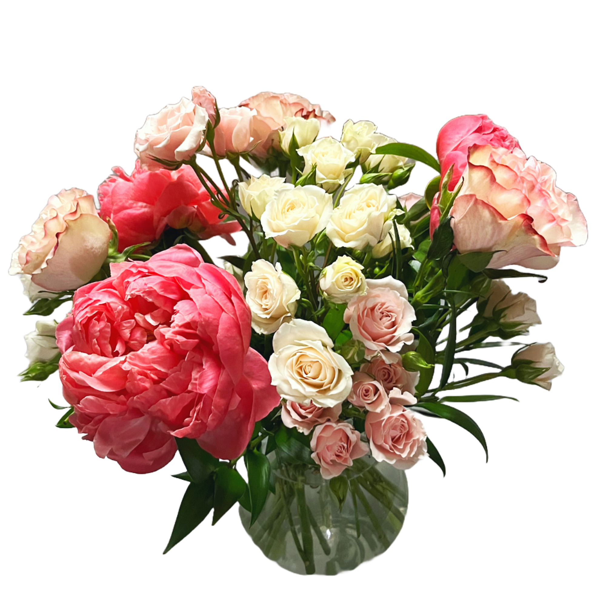 Pink and white roses arranged in a clear glass vase