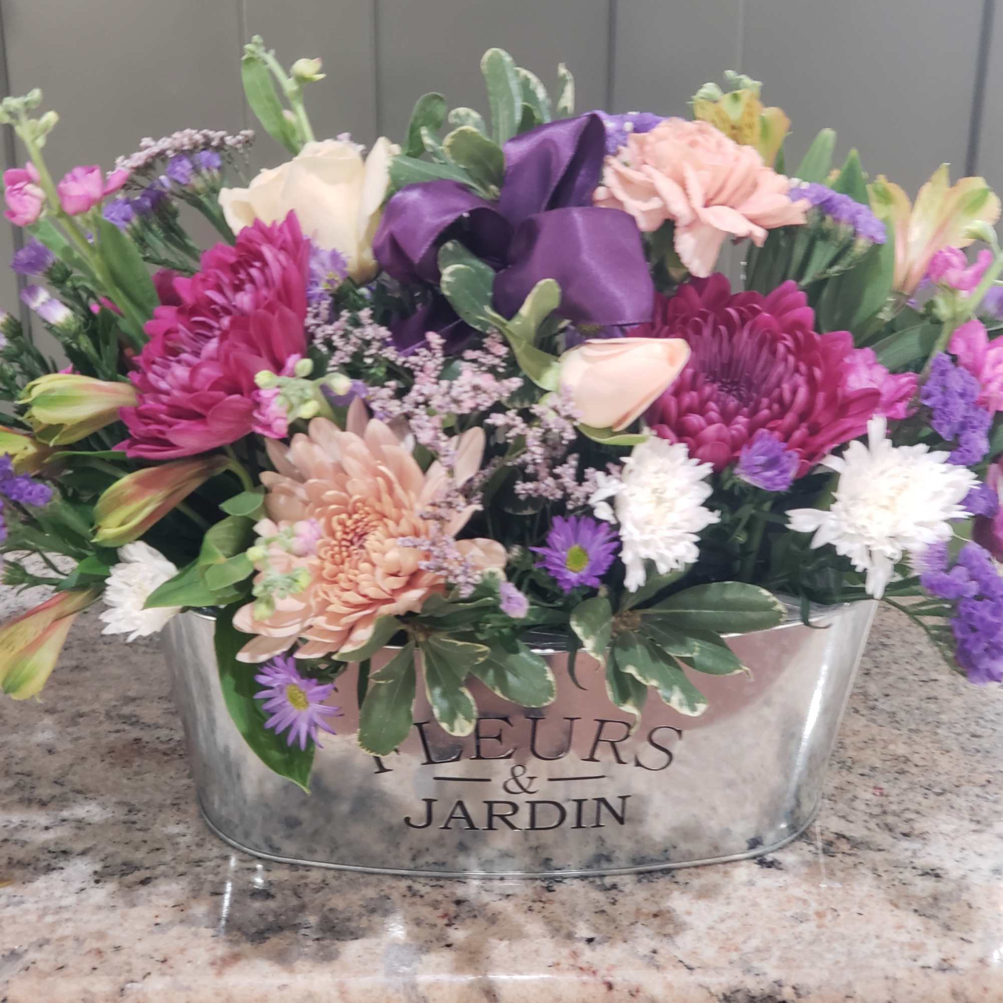 NOTE! Limited qty of containers and blush tone flowers...would substitute! 
Keepsake, oval