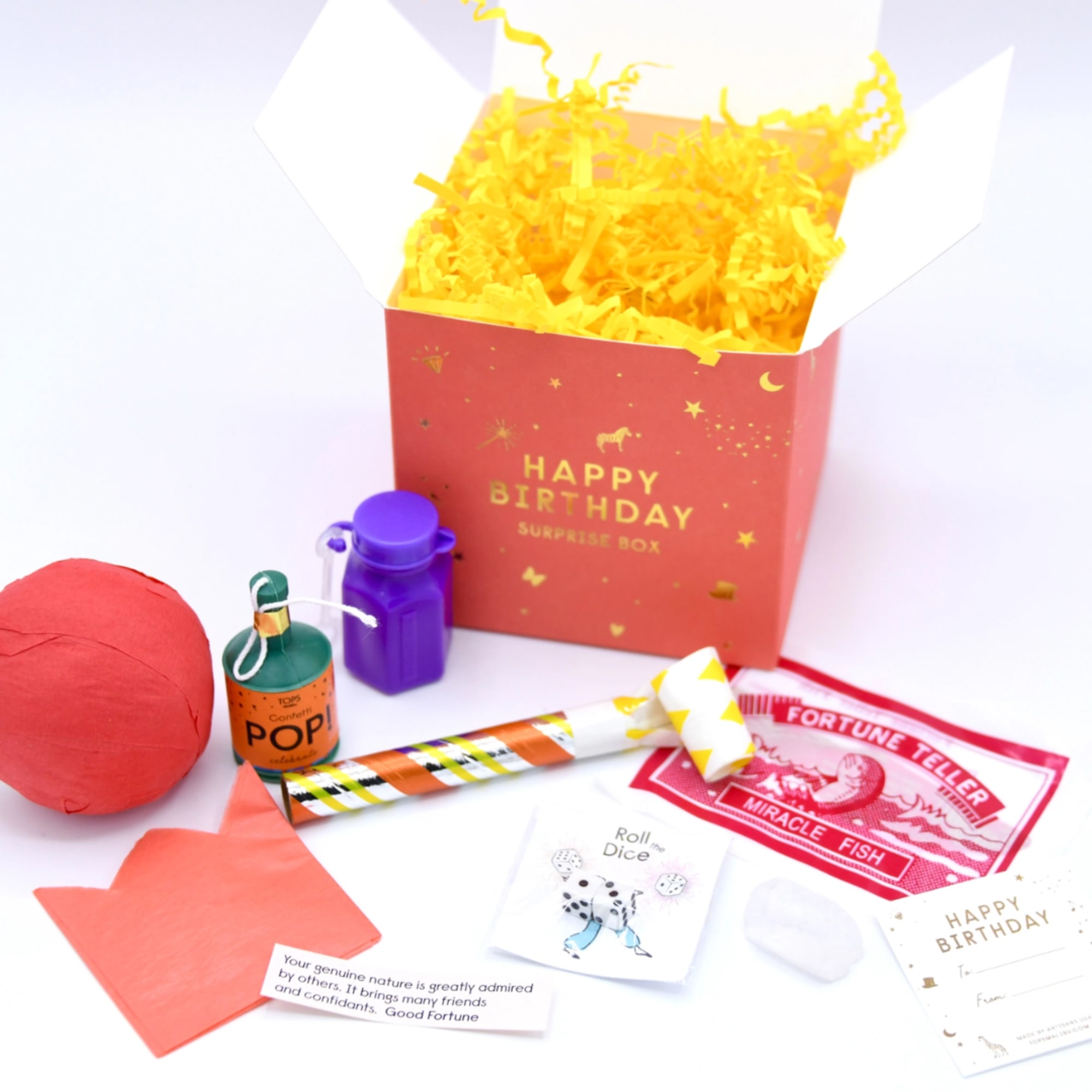 Birthday surprise box with confetti, party favors, and cards on a white background