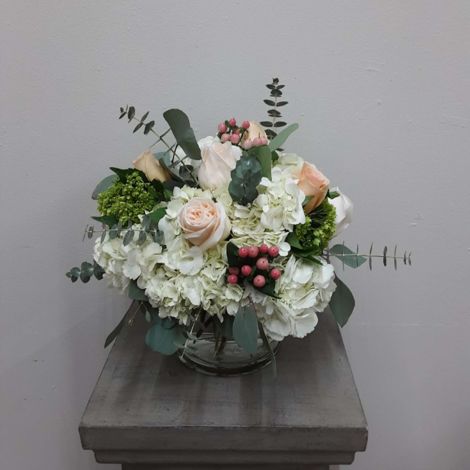 White and blush rose arrangement in a glass vase