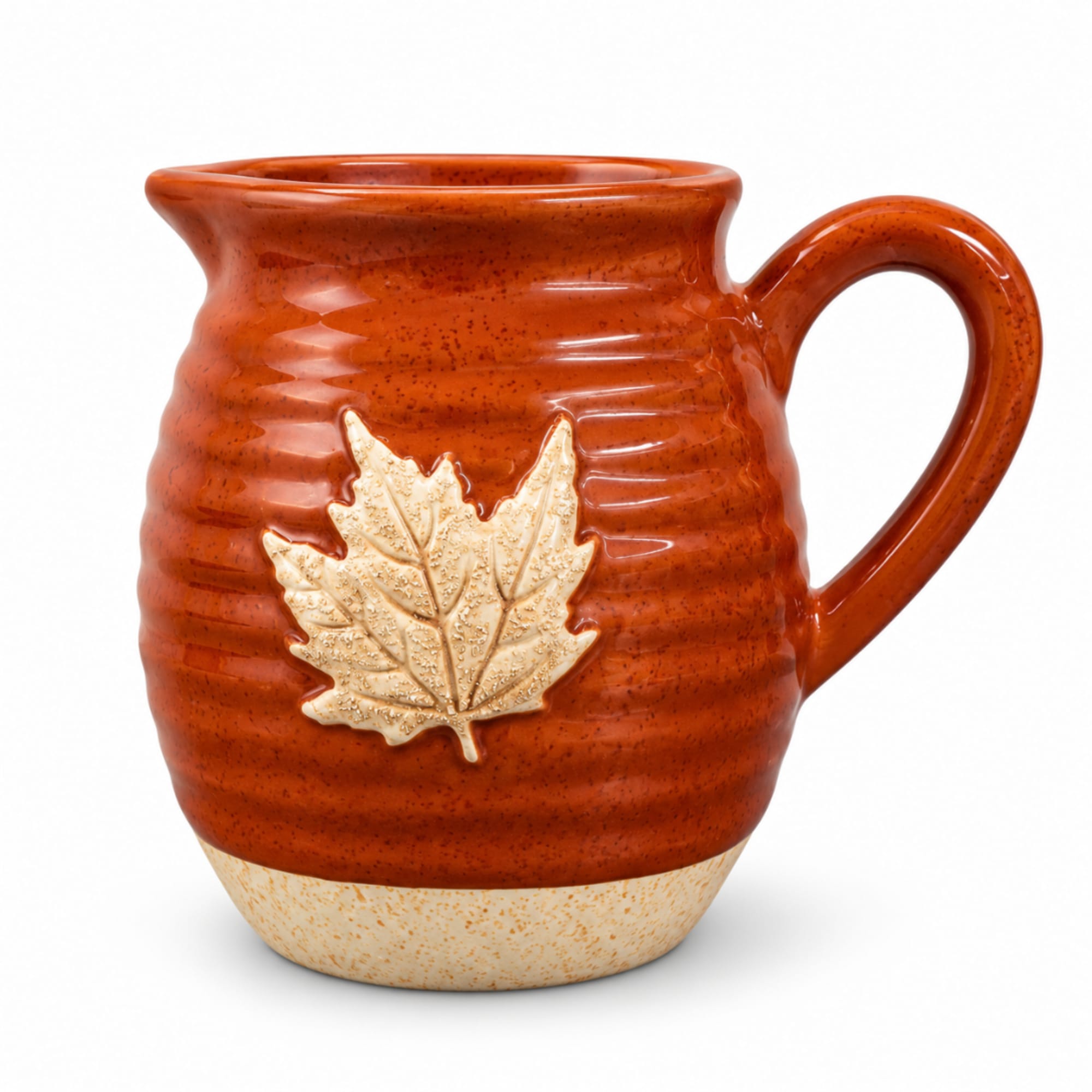 Ceramic mug with a maple leaf design on a white background
