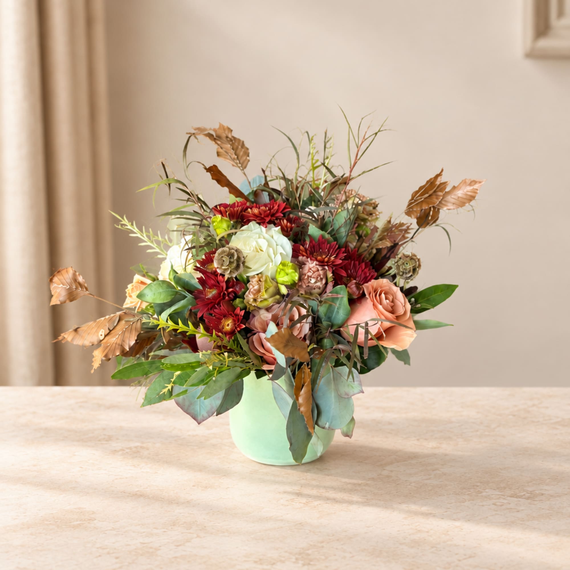Mixed bouquet of red, peach, and white flowers in a mint vase