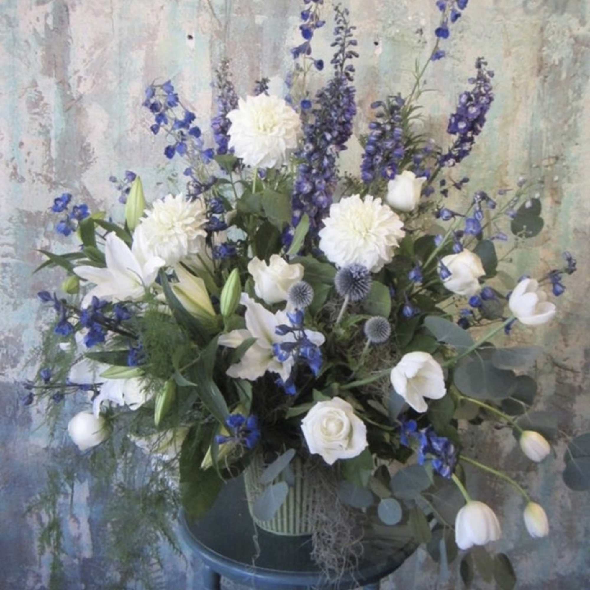White and blue floral arrangement in a vase