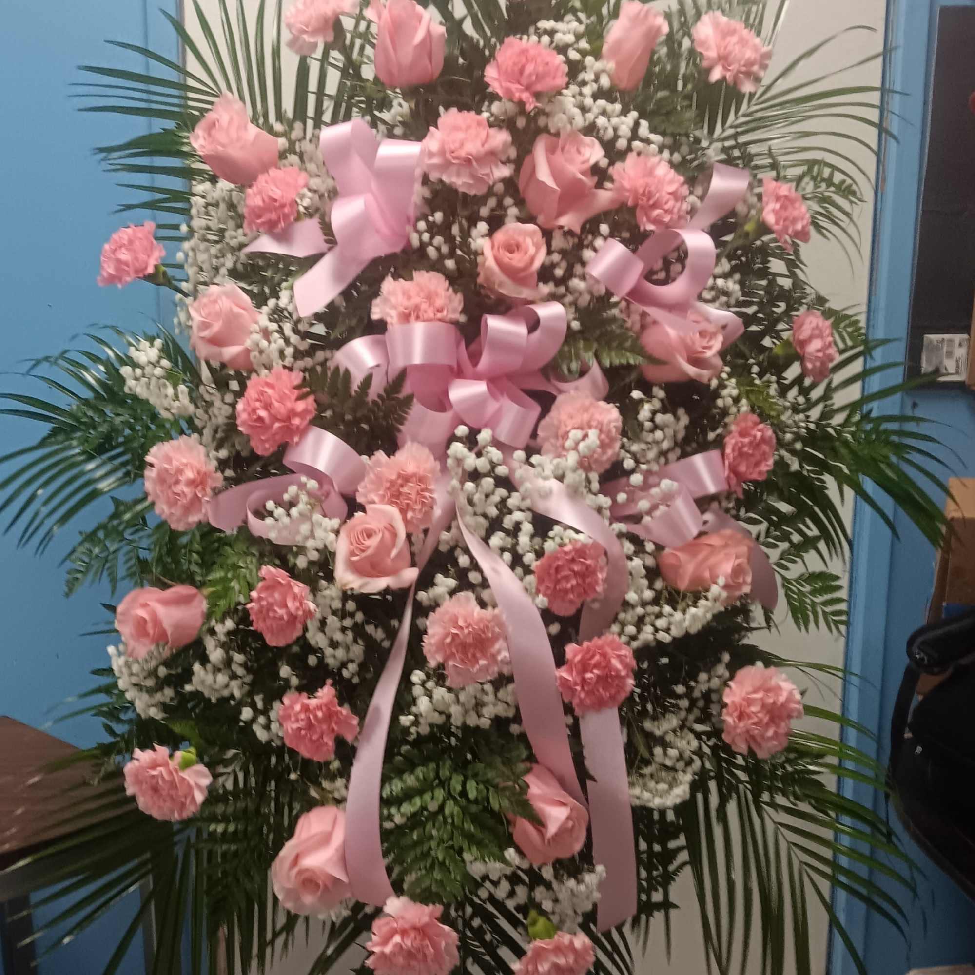 Tall pink floral standing spray with roses and carnations