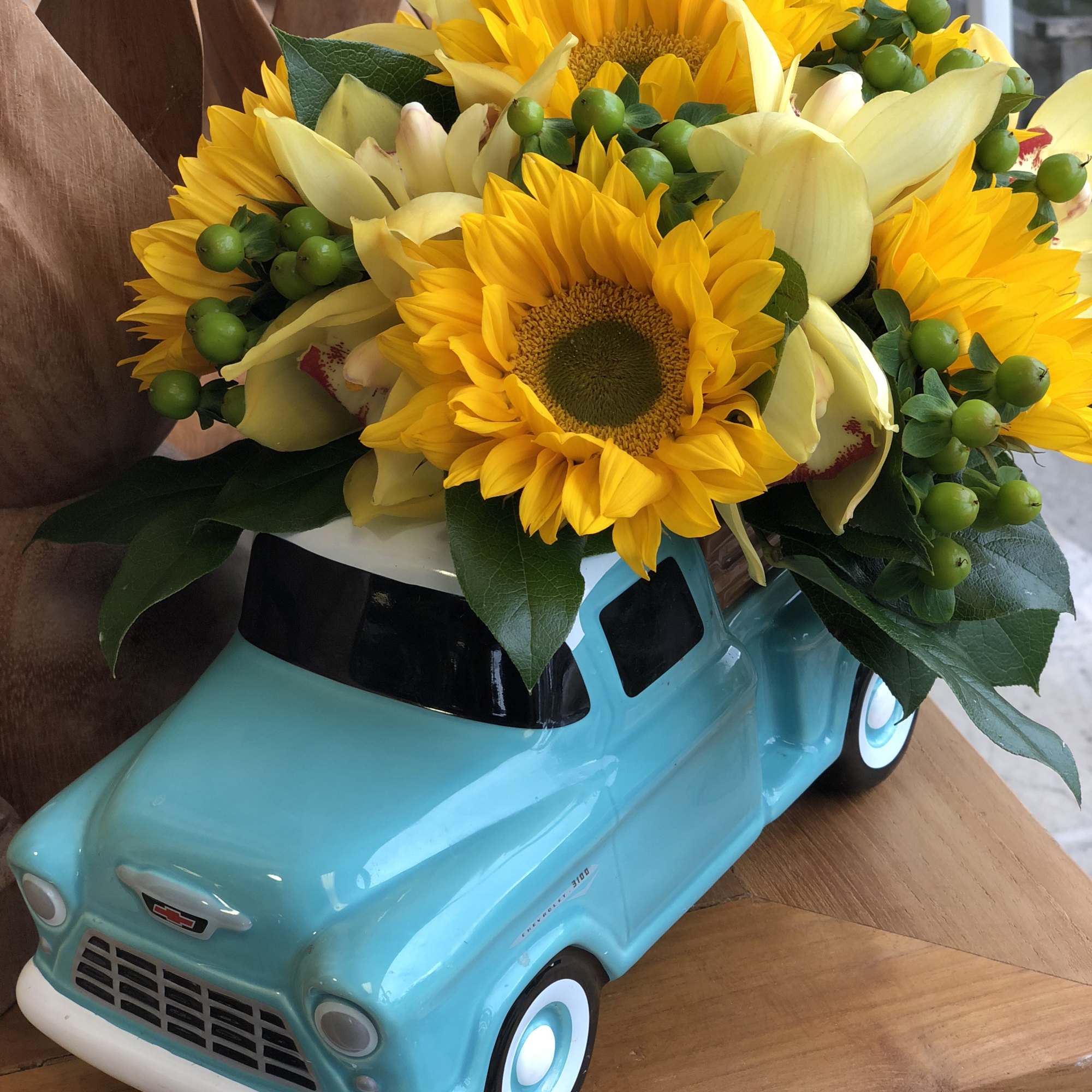 Sunflower bouquet in a turquoise toy truck planter