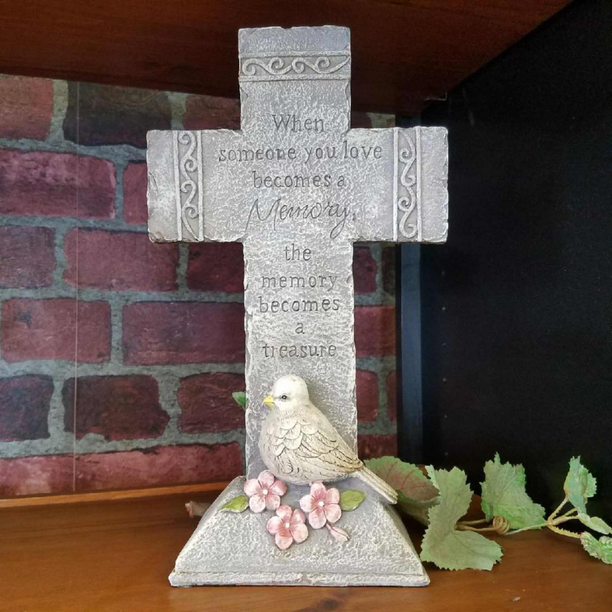 Decorative memorial cross with a bird and pink flowers