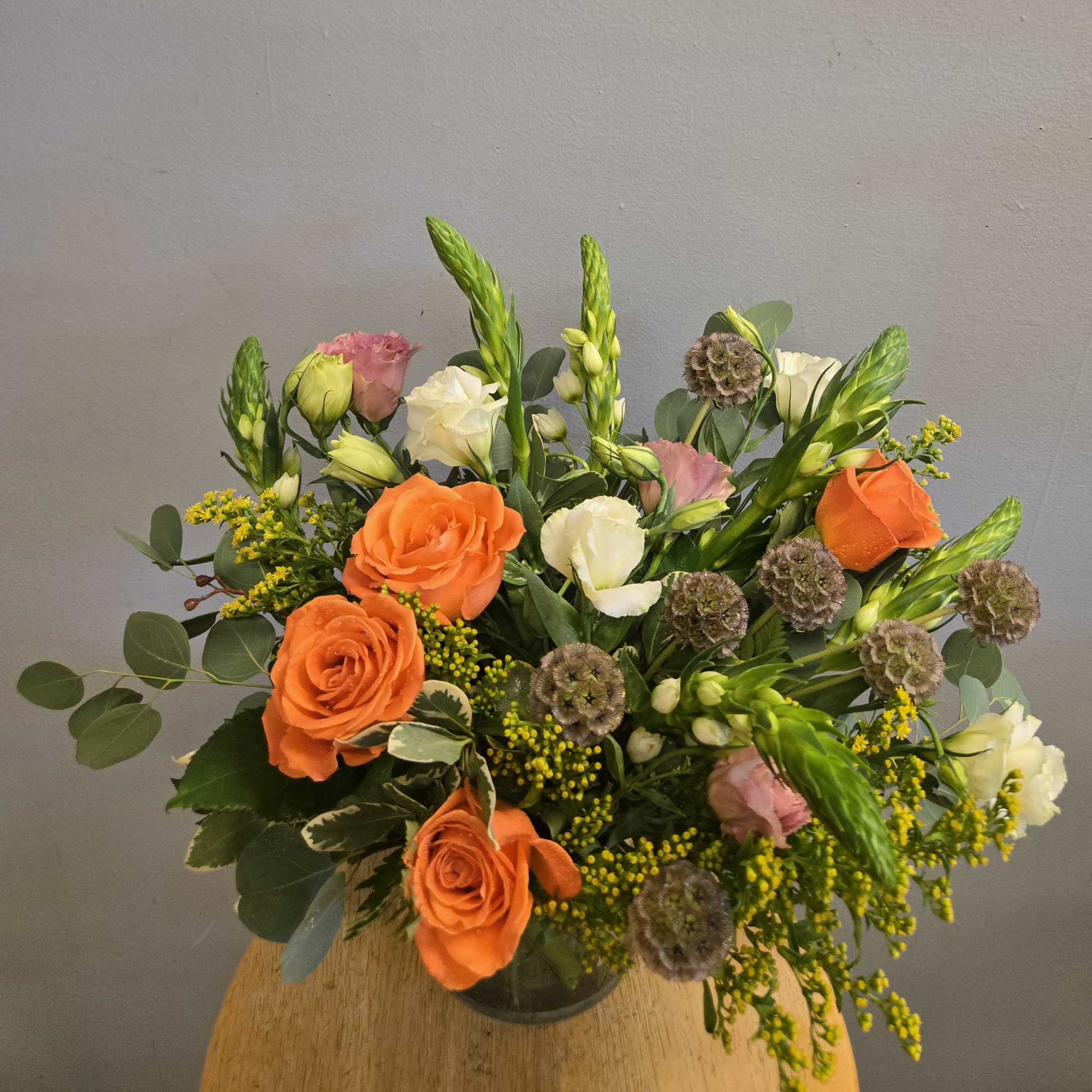 Bright orange roses take center stage in this garden-style flower arrangement, a, photo 2 of 2