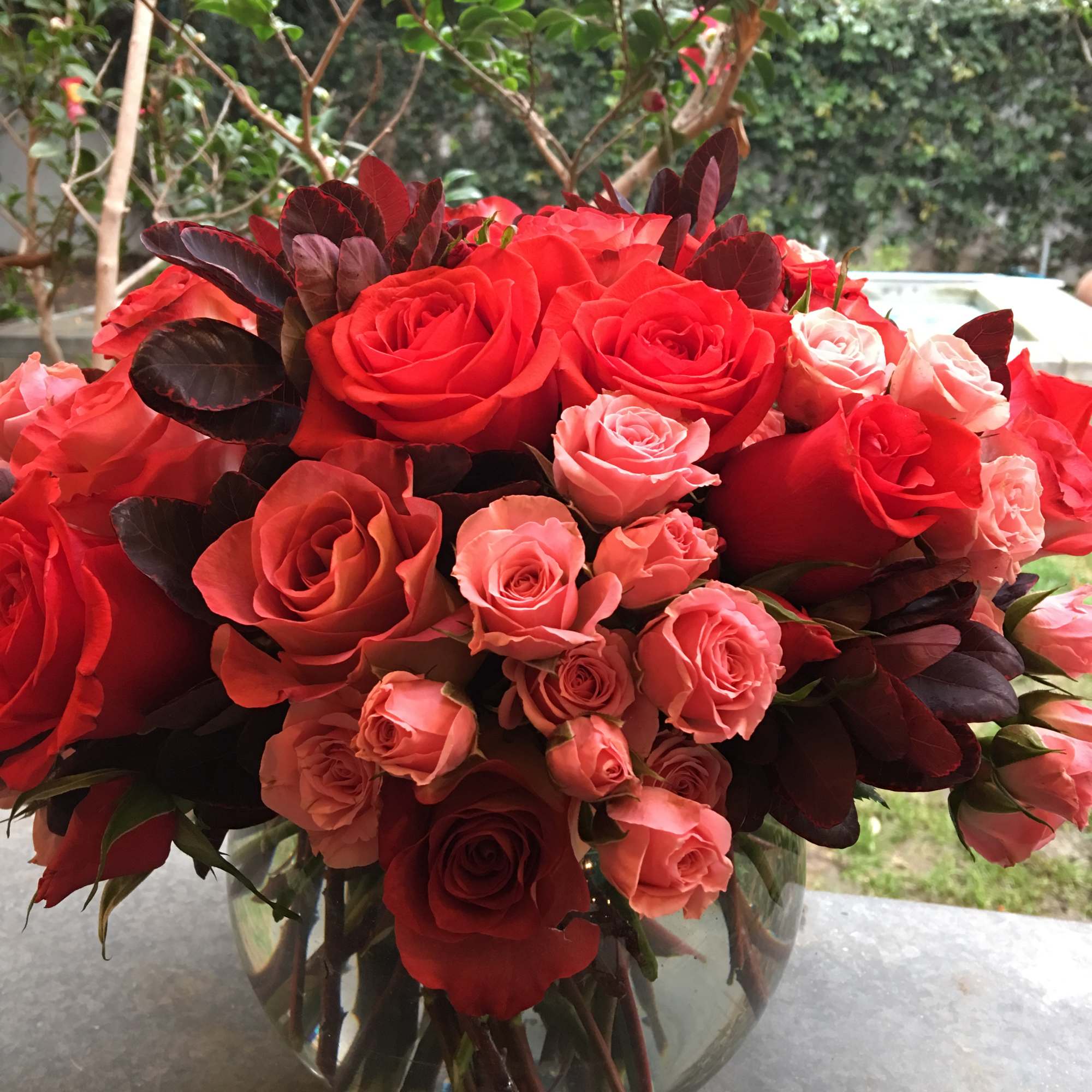 Bouquet of red and pink roses in a clear glass vase