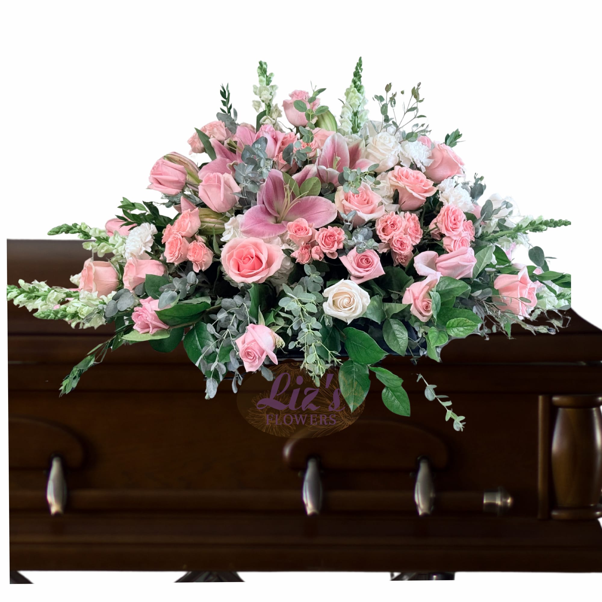 Pink and white floral casket spray with roses and lilies