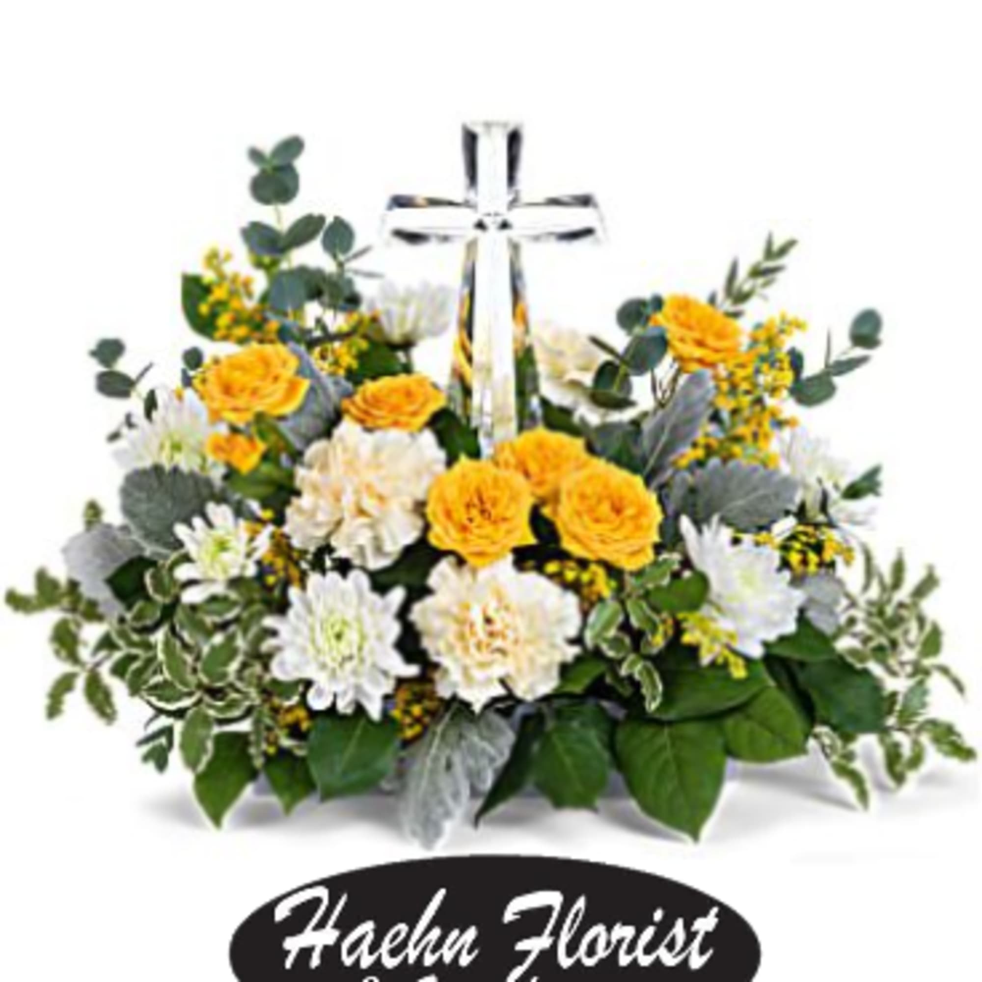 Yellow and white flower arrangement with a clear cross centerpiece