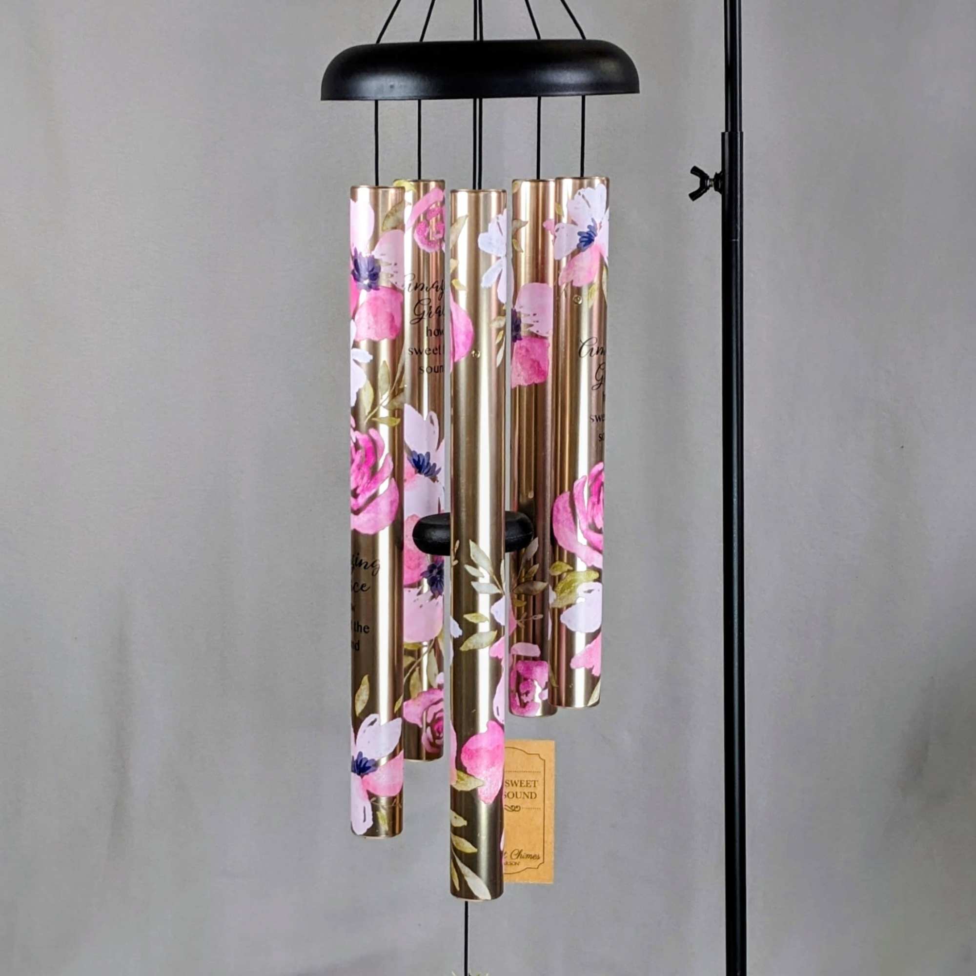 Black metal wind chime with gold floral tubes and a black clapper