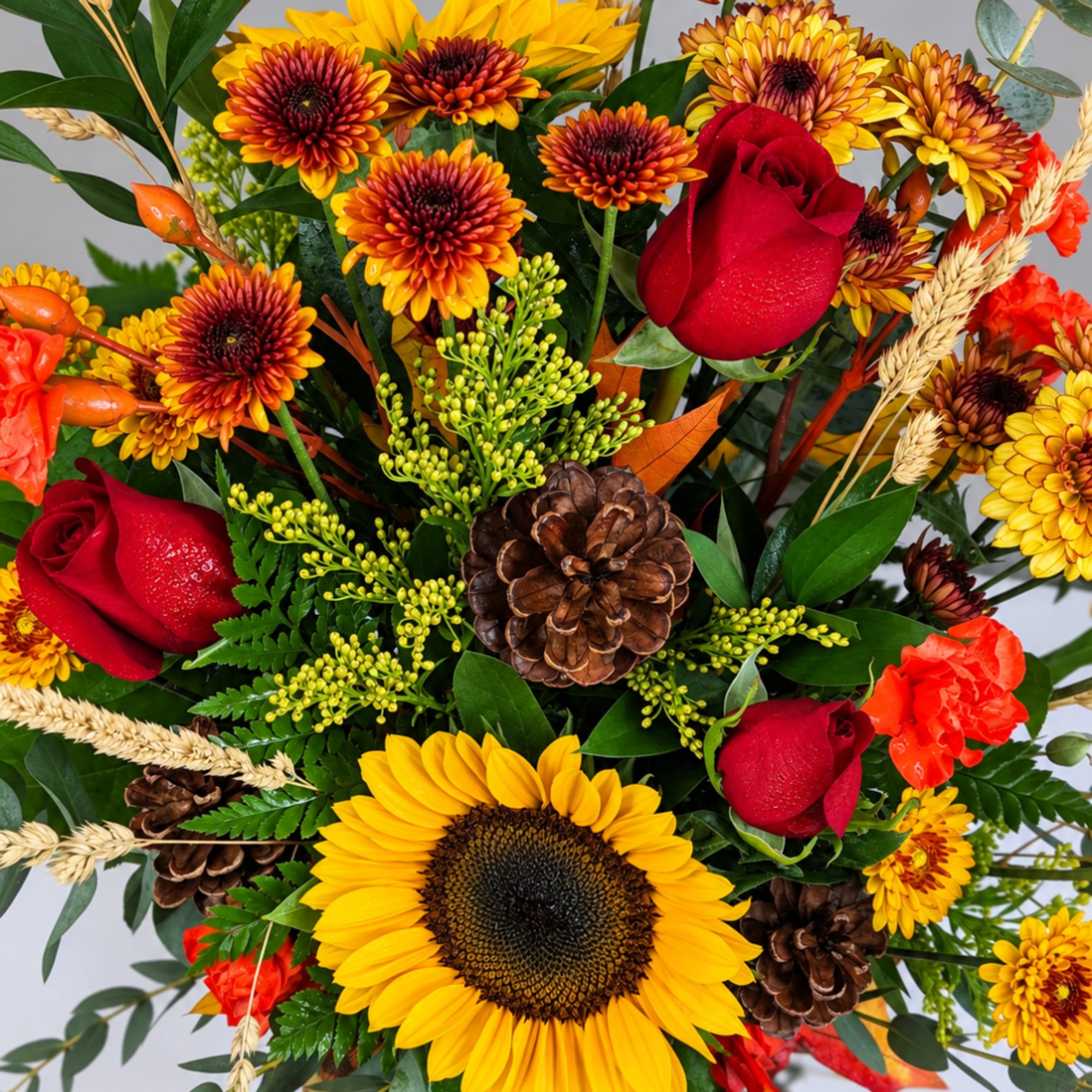 Bouquet with red roses, yellow sunflowers, and orange chrysanthemums