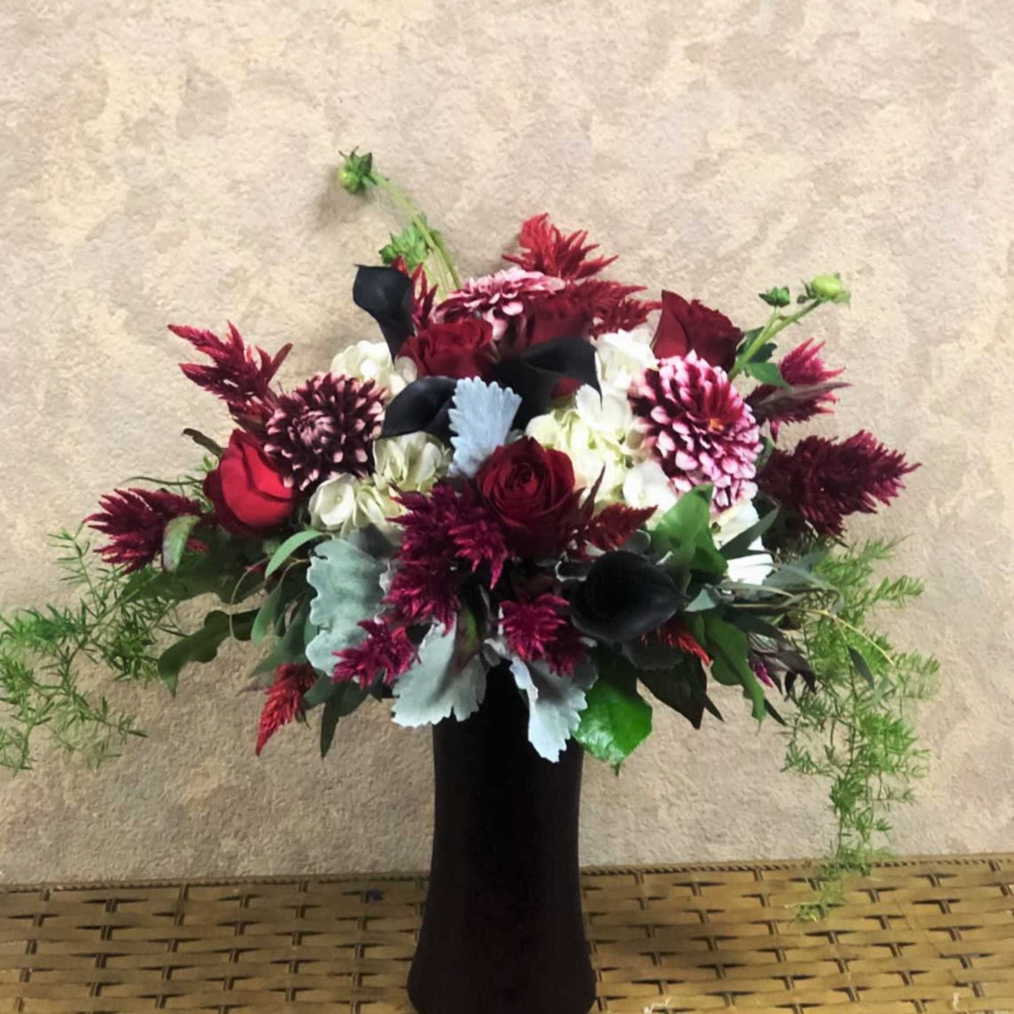 Red and white floral arrangement in a black vase, photo 2 of 2