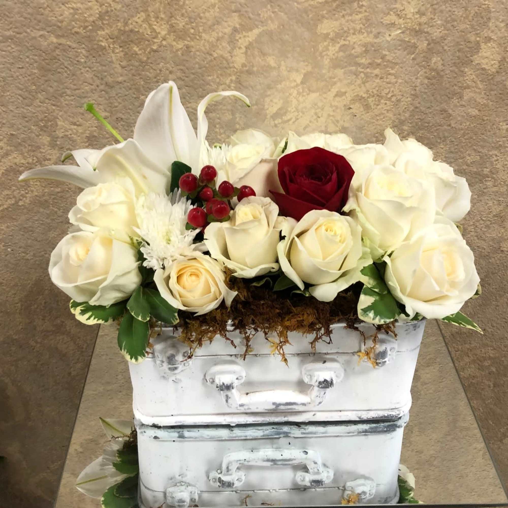 White and red roses arranged in a white box with a white lily