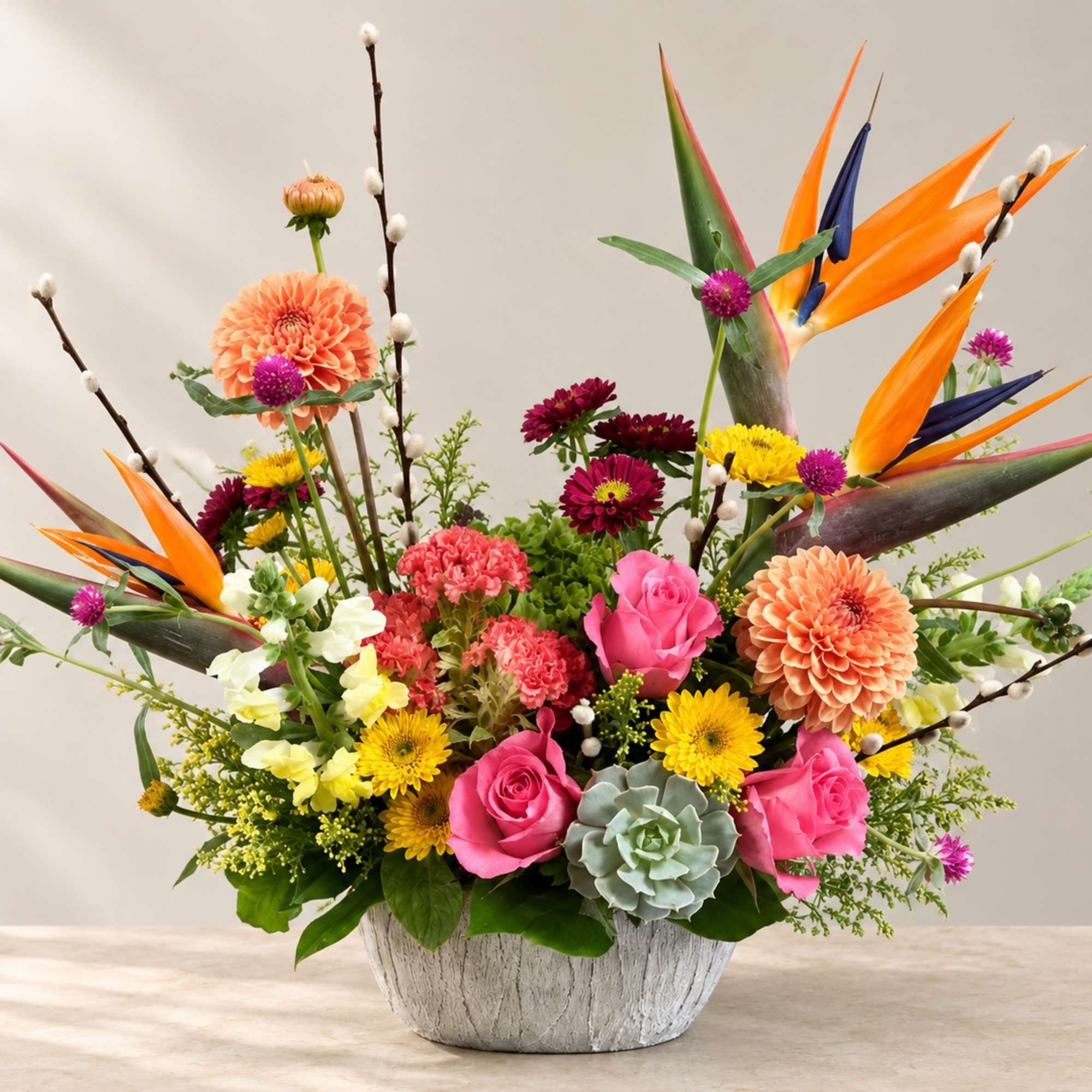 Colorful mixed flower arrangement in a white textured bowl vase