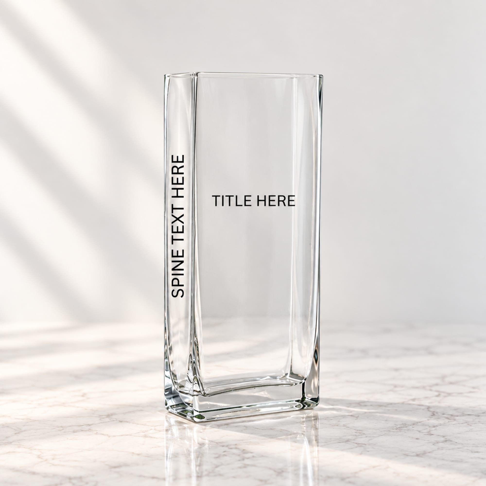 Clear rectangular glass vase with placeholder text on a marble surface