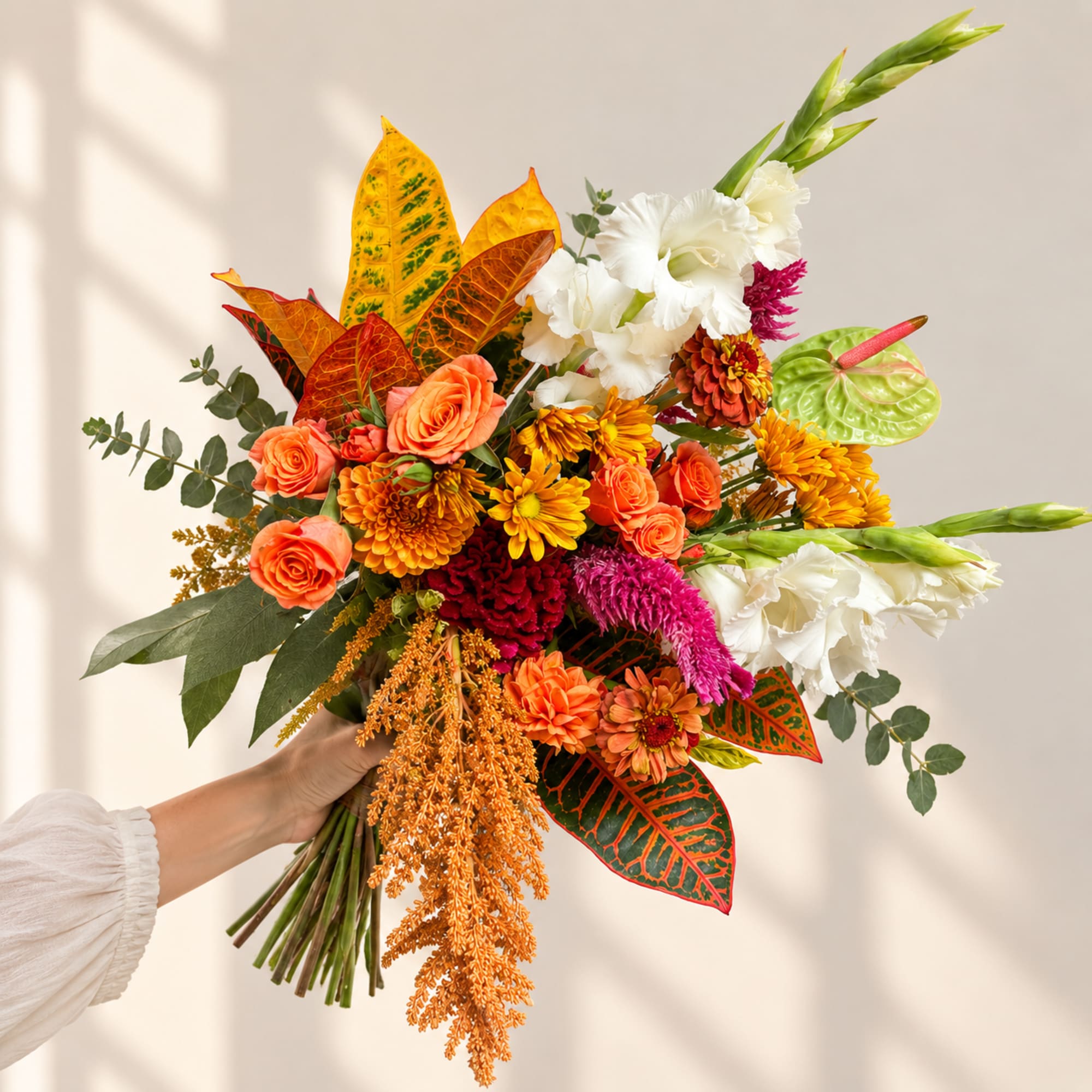 Handheld bouquet with orange, white, and yellow flowers