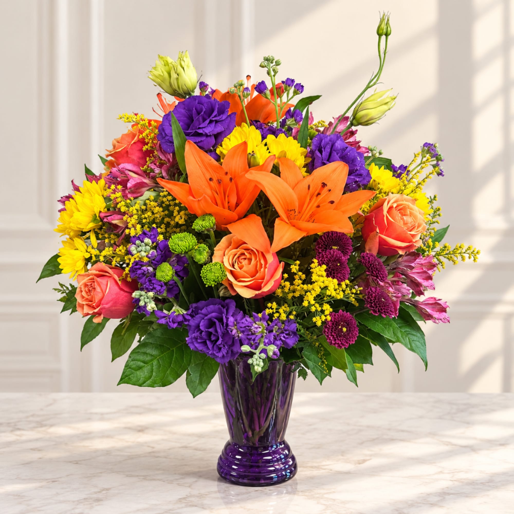 Colorful bouquet of lilies, roses, and chrysanthemums in a purple vase