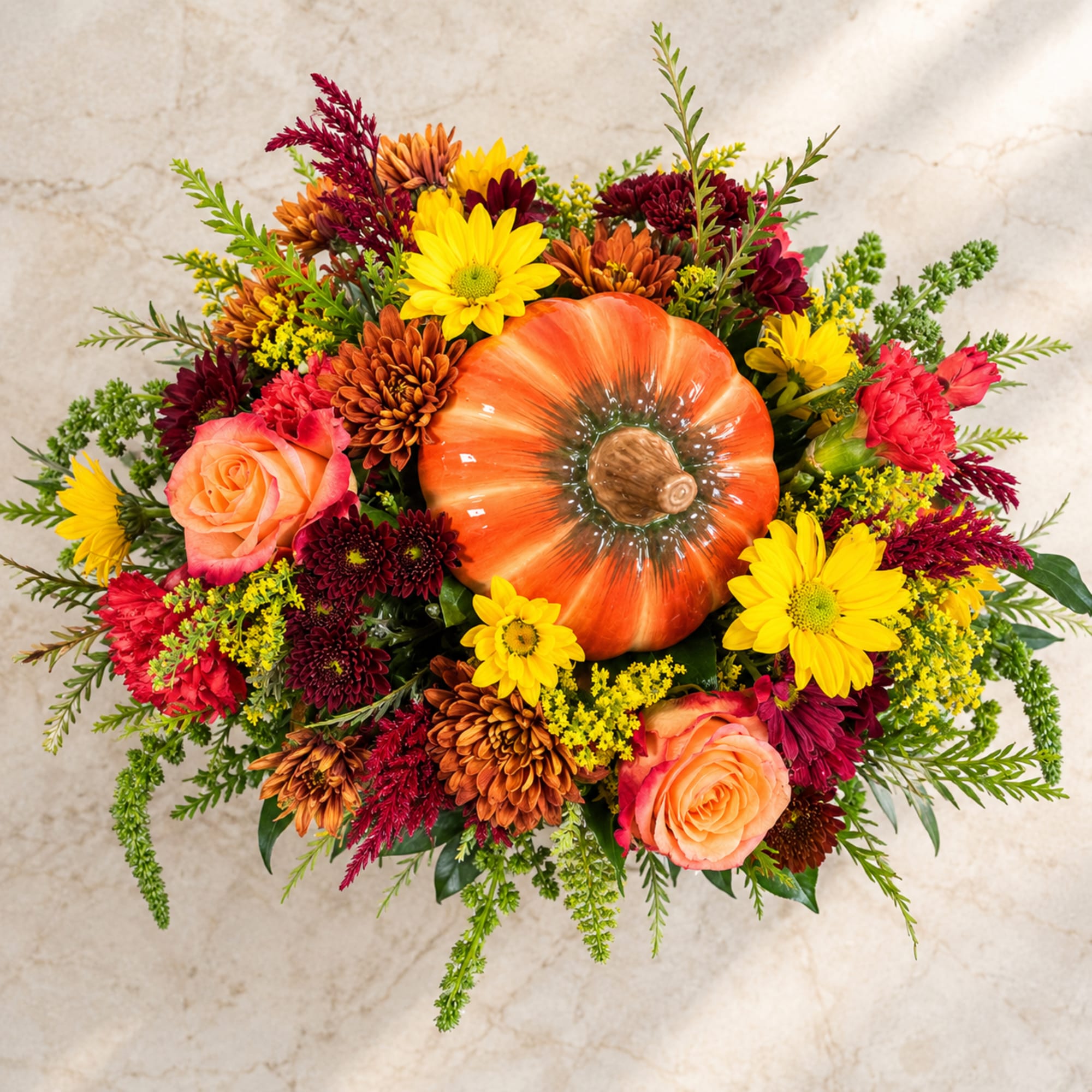 Autumn bouquet with a pumpkin centerpiece and mixed flowers