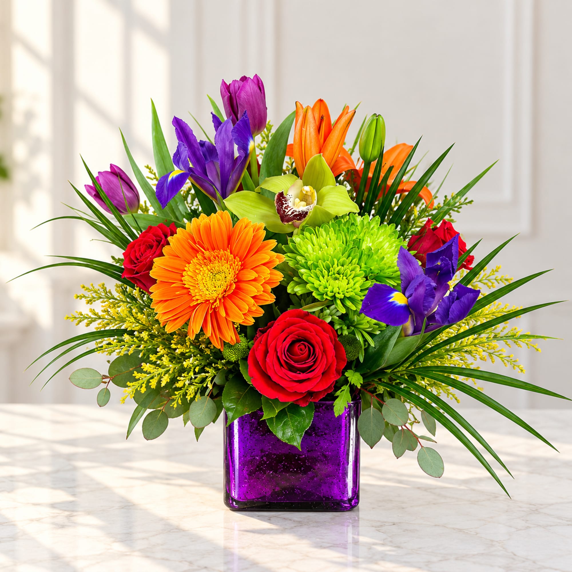 Colorful bouquet in a purple glass vase with roses, gerbera daisies, lilies, and irises
