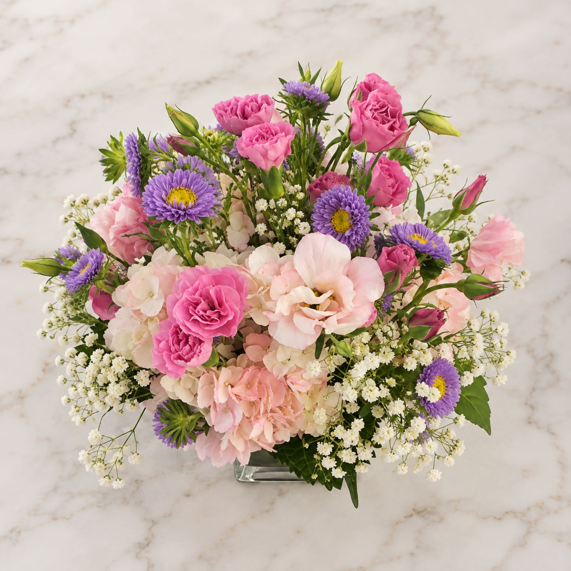 Sweet Pea centerpiece has Magenta and Pink Lisianthus, Purple Matsumoto Asters, Pink