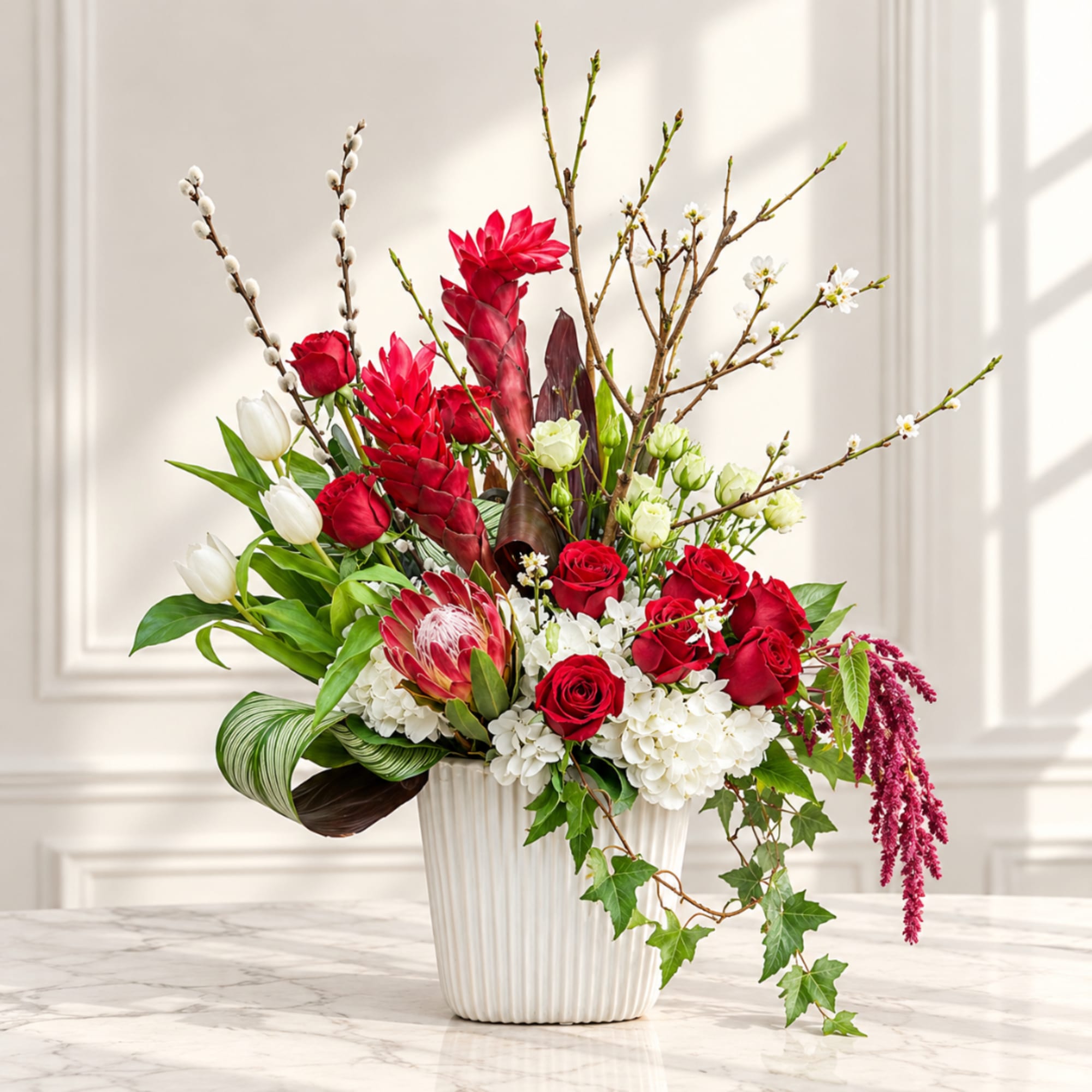 Red roses and white tulips in a white vase with tall branches