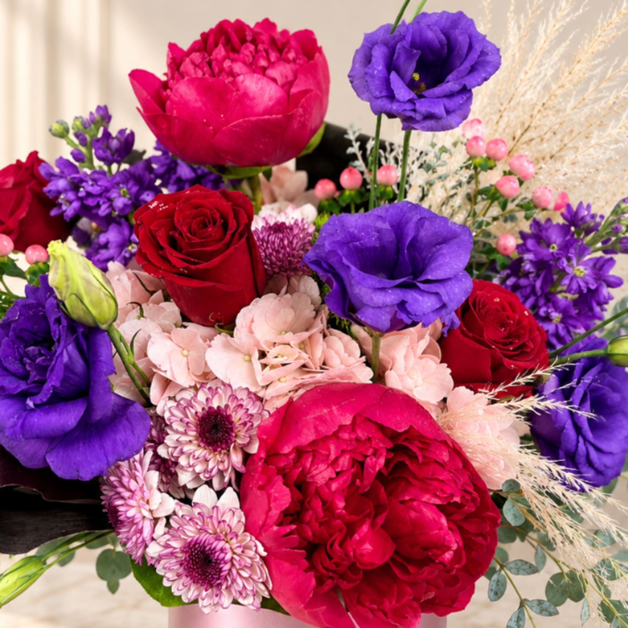 Bouquet of red, pink, and purple flowers in a vase