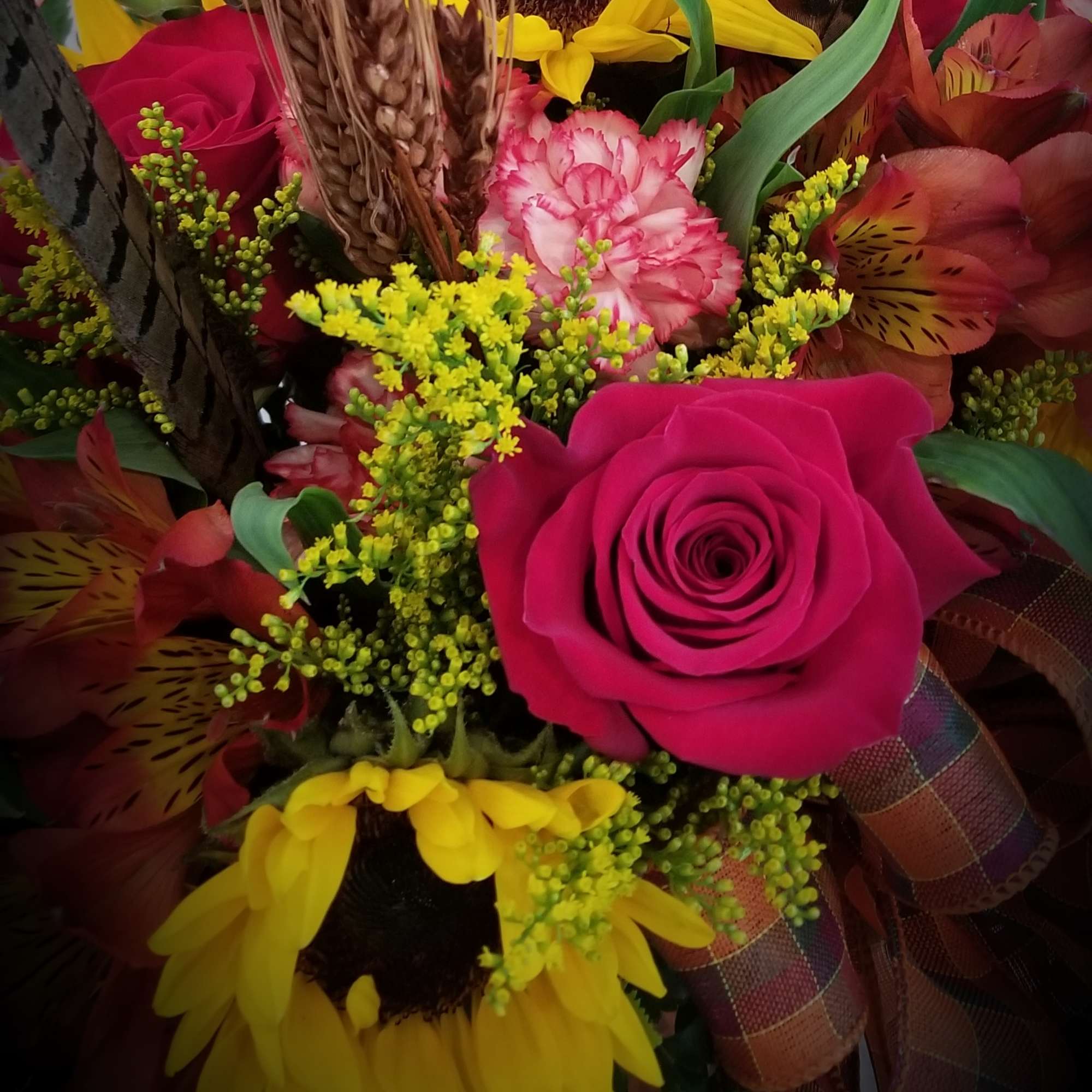 A traditional arrangement of roses, sunflowers asters, alstroemeria and other flowers accented, photo 2 of 2