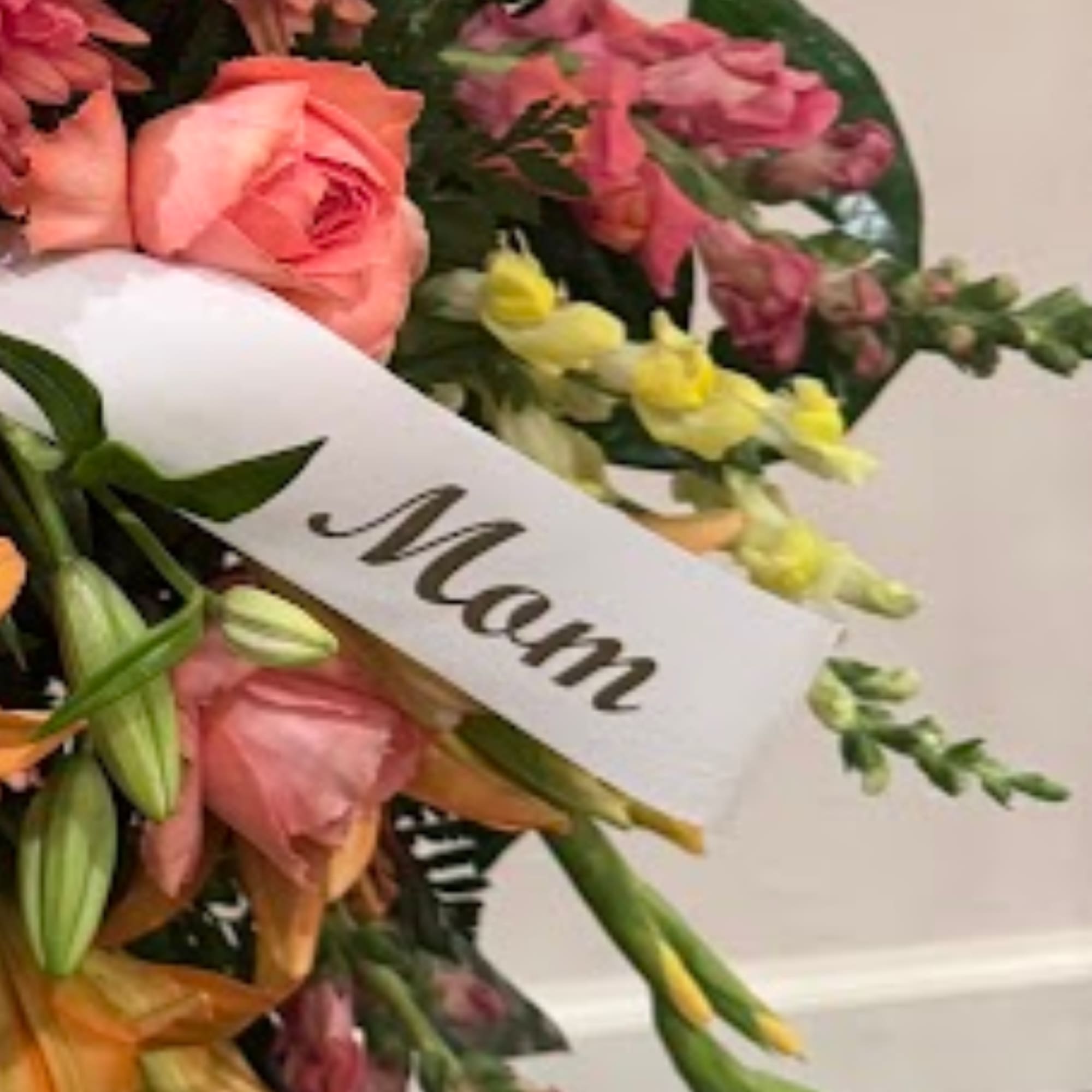 Mixed bouquet with pink roses, lilies, and snapdragons, labeled "Mom"