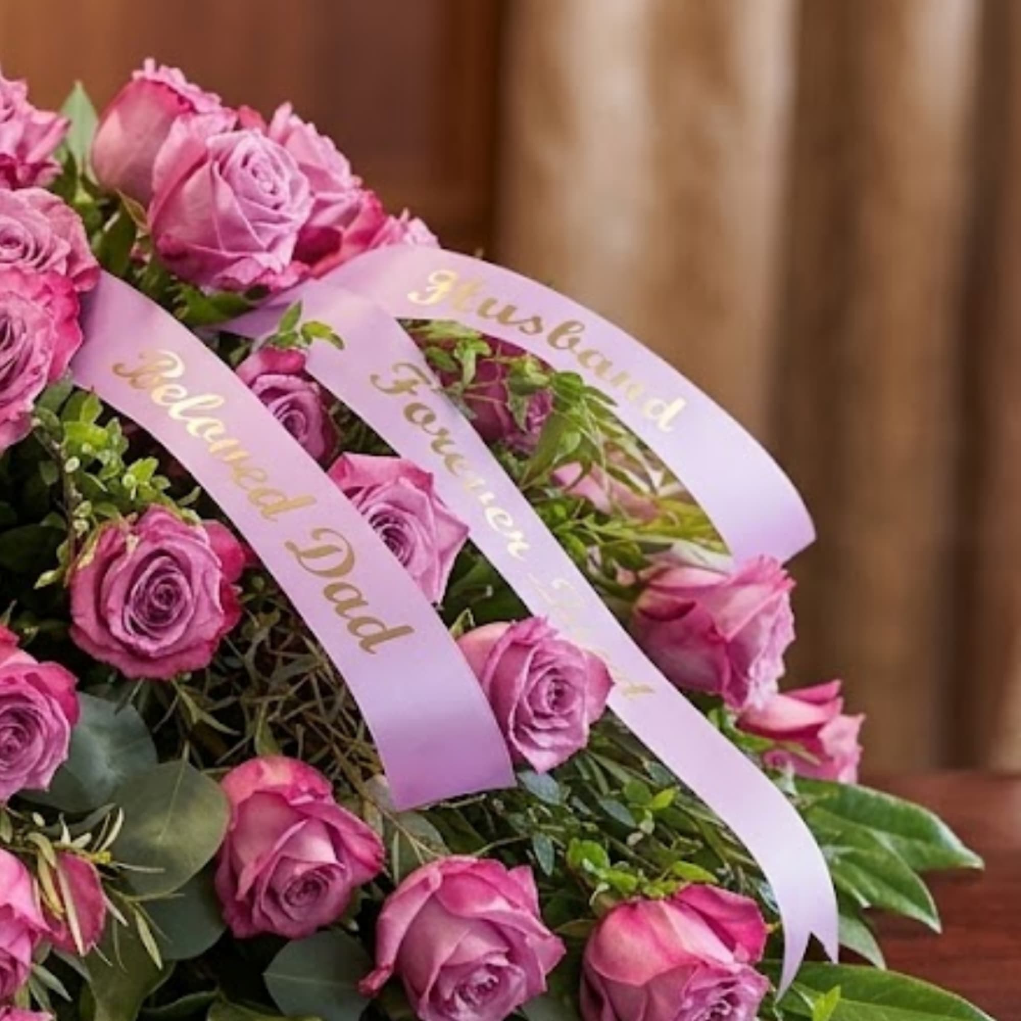 Pink rose bouquet with lavender ribbons reading "Beloved Dad" and "Husband"