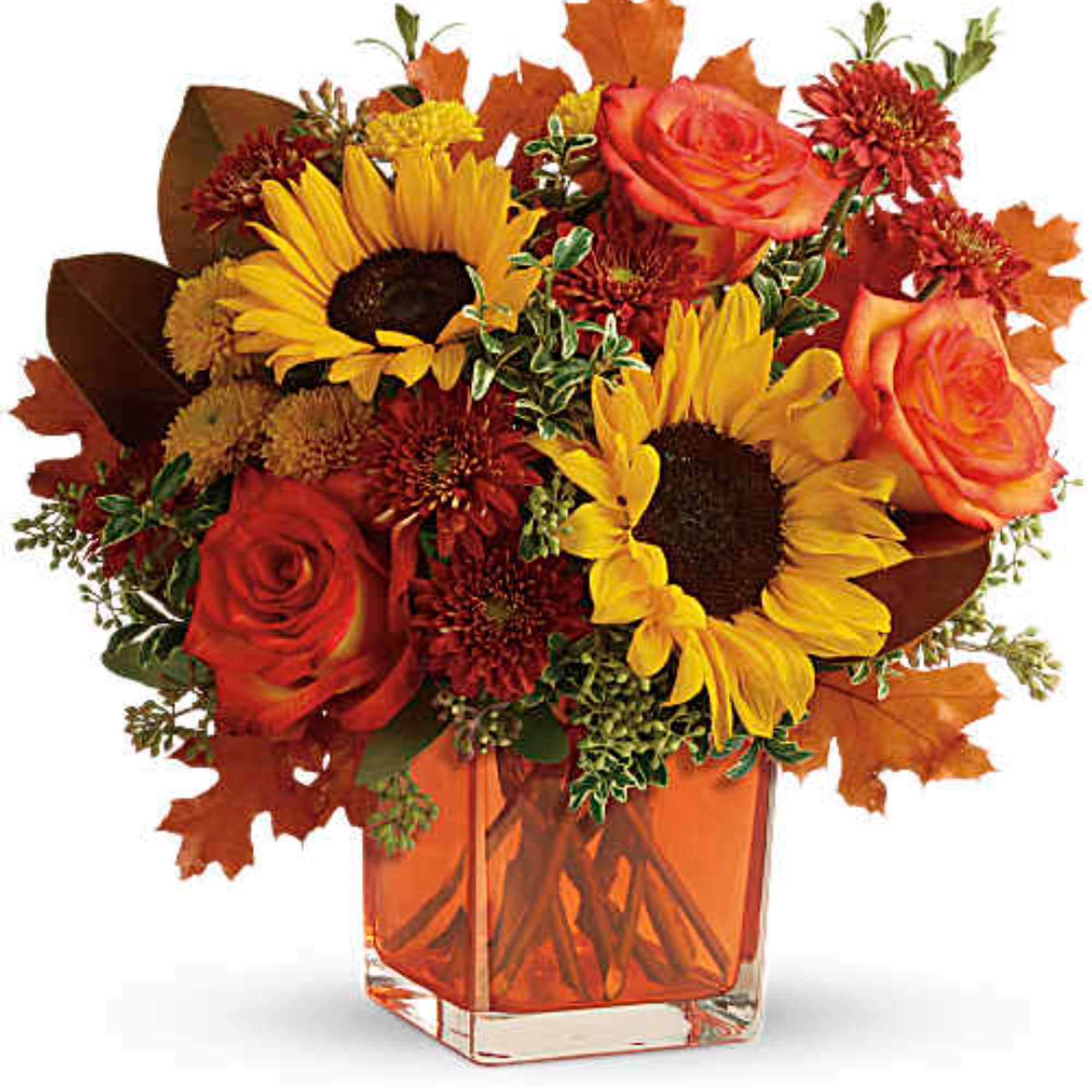 Autumn bouquet with sunflowers, roses, and mums in an orange glass vase