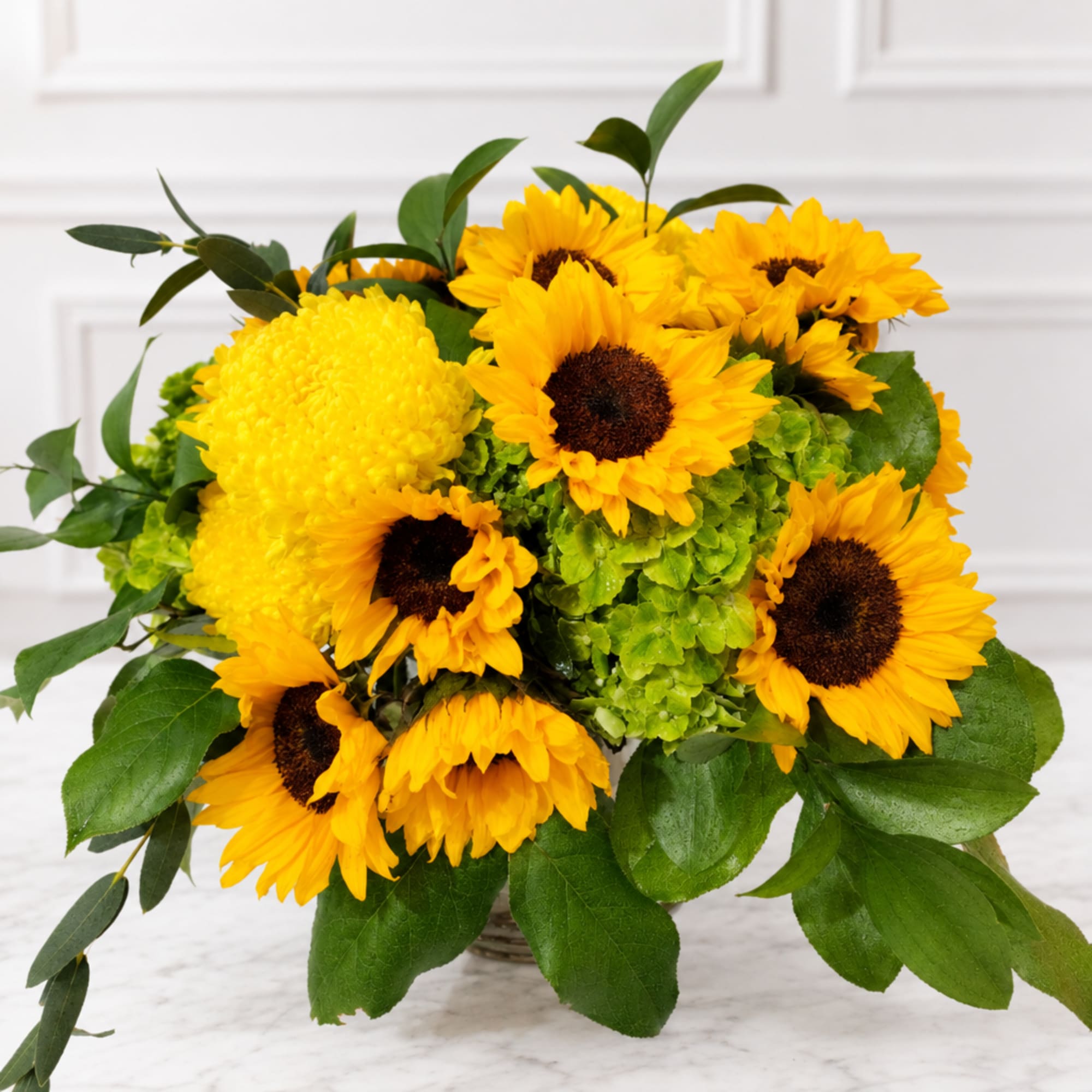 Yellow sunflowers and mums arranged in a basket