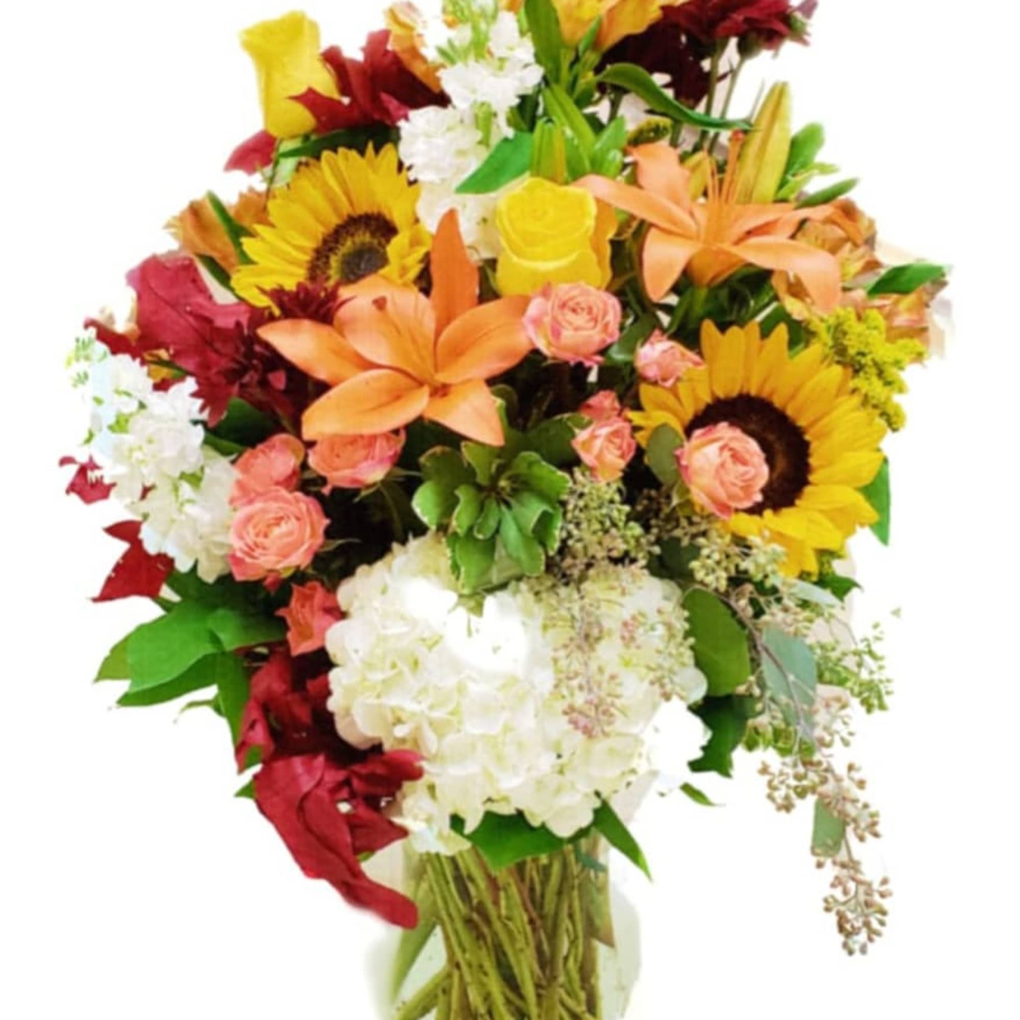 Mixed bouquet with sunflowers, lilies, roses, and white hydrangeas in a glass vase