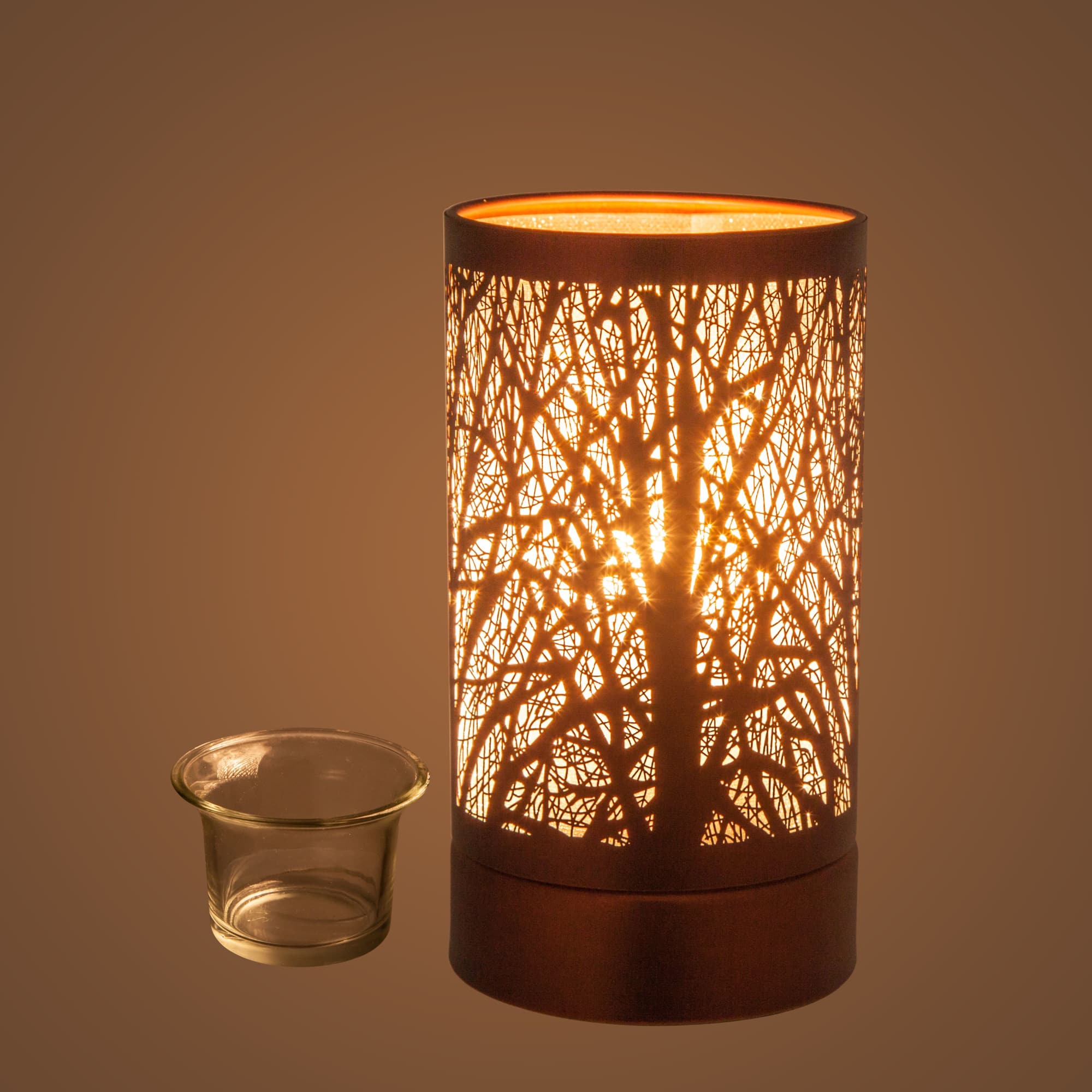 Lit decorative candle lamp with a small glass votive holder