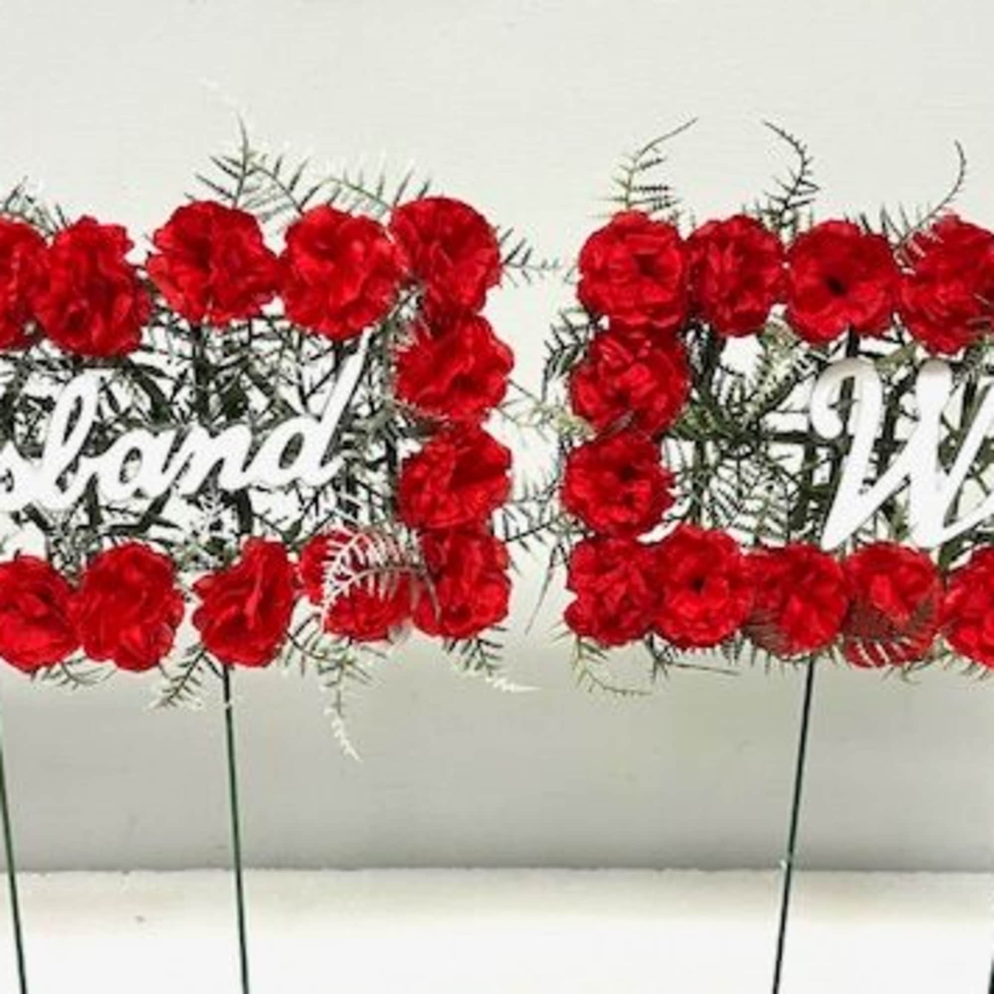Red floral signs reading Husband and Wife