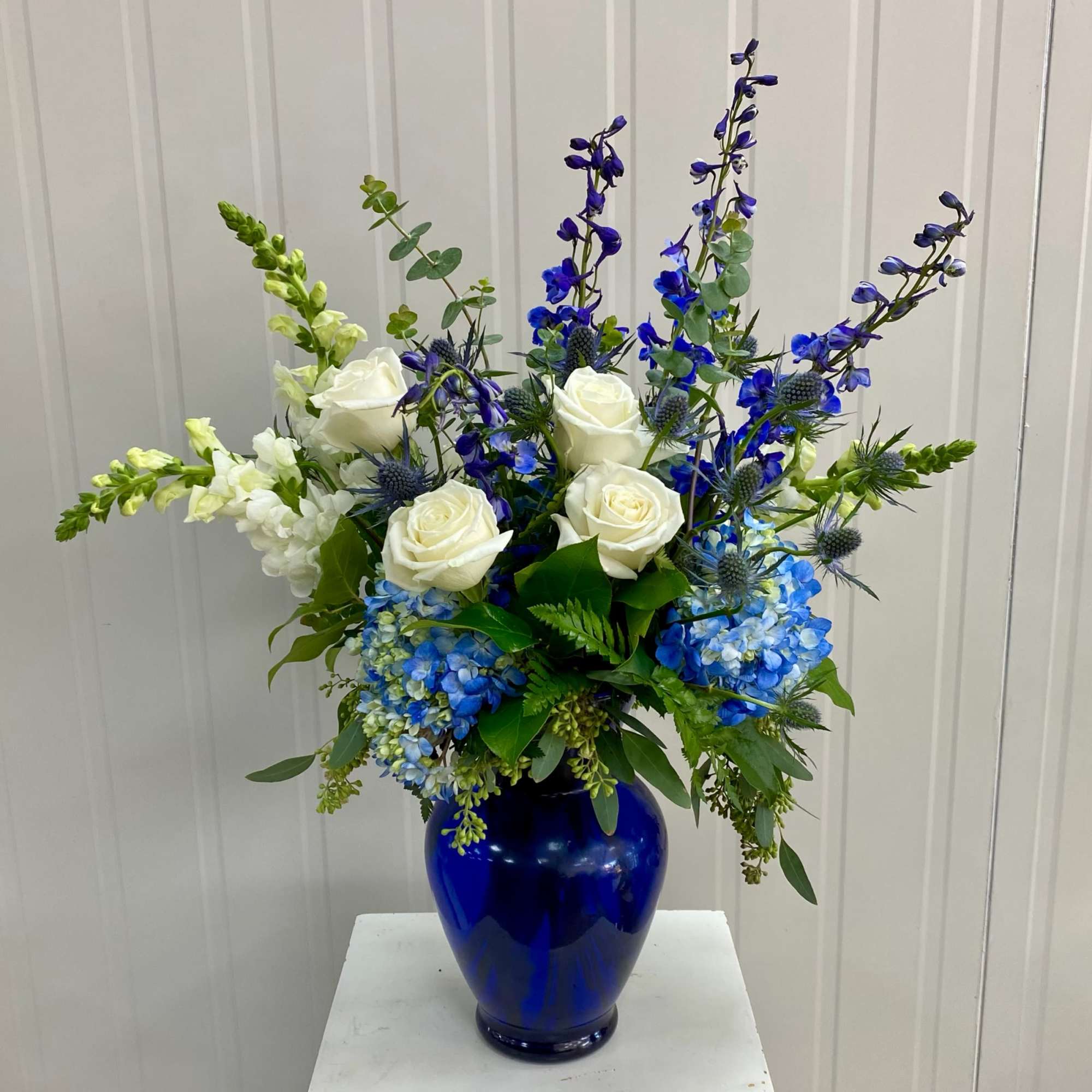 This Arrangement Includes White Roses, Blue Hydrangea, Blue Thistle, Blue Delphinium and
