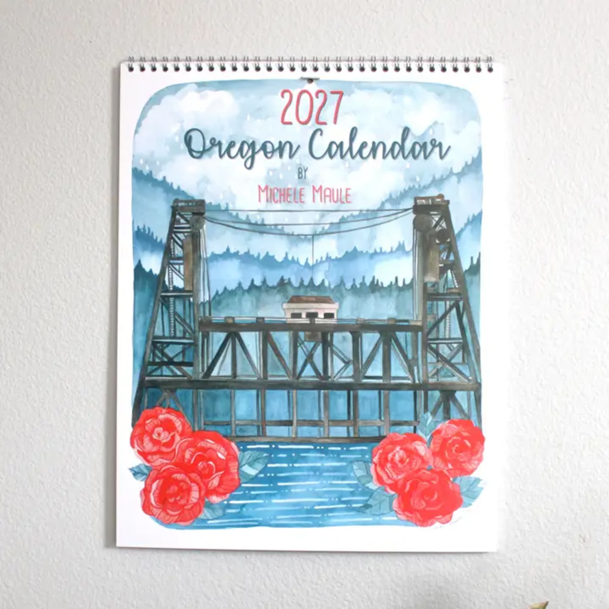 Spiral-bound 2027 Oregon calendar with red roses at the bottom